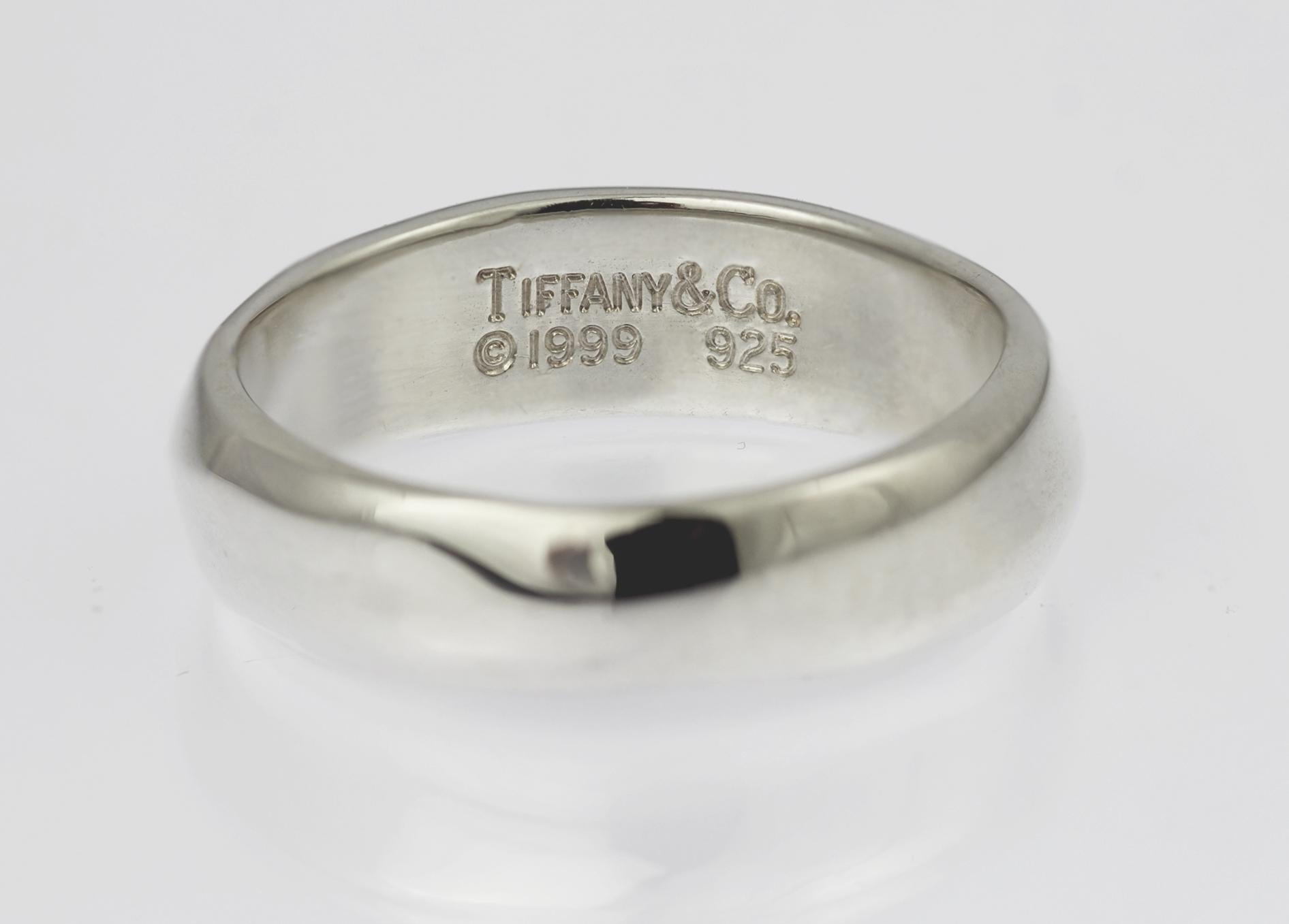 Hautement polie et subtilement profilée avec une vague courant le long de l'anneau jusqu'à un très léger dôme, cette bague Tiffany est estampillée à l'intérieur 