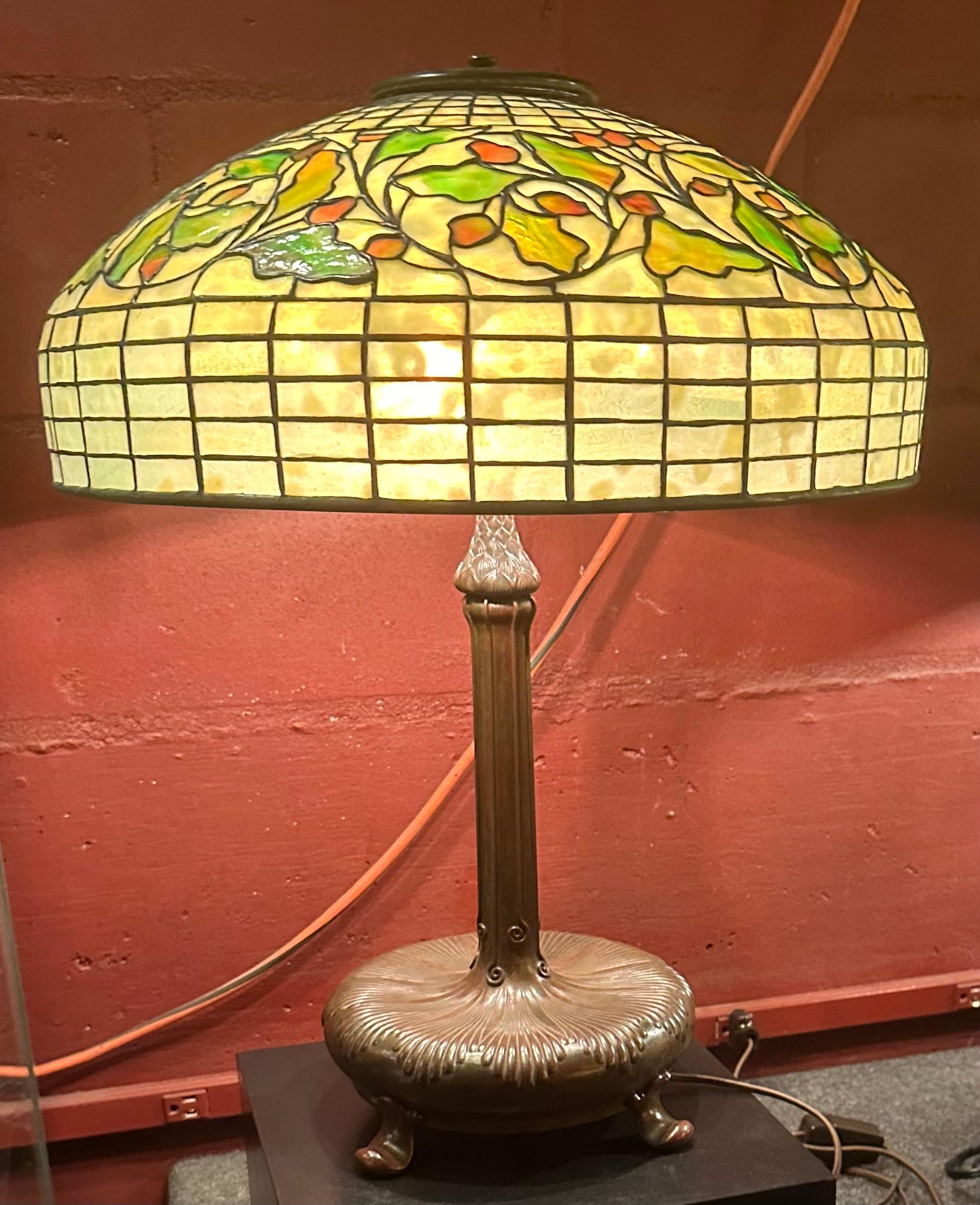 A Tiffany Studios 18” geometric lampshade with a wide circumferential Oak and Berry band just above the shoulder of the shade.The shade is signed 