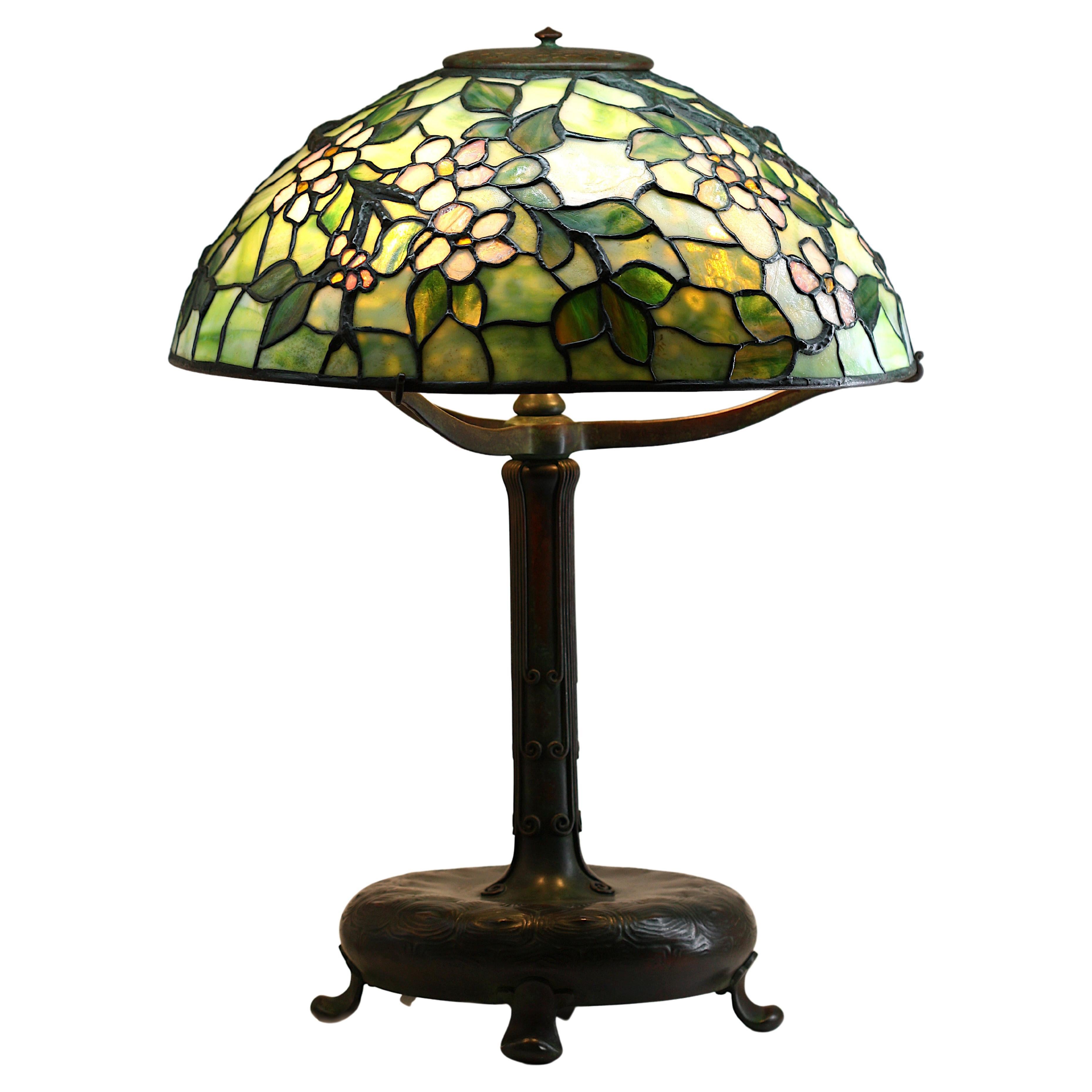 TIFFANY STUDIOS (1899-1920) "Apple Blossom" Leaded Glass and Bronze Table Lamp