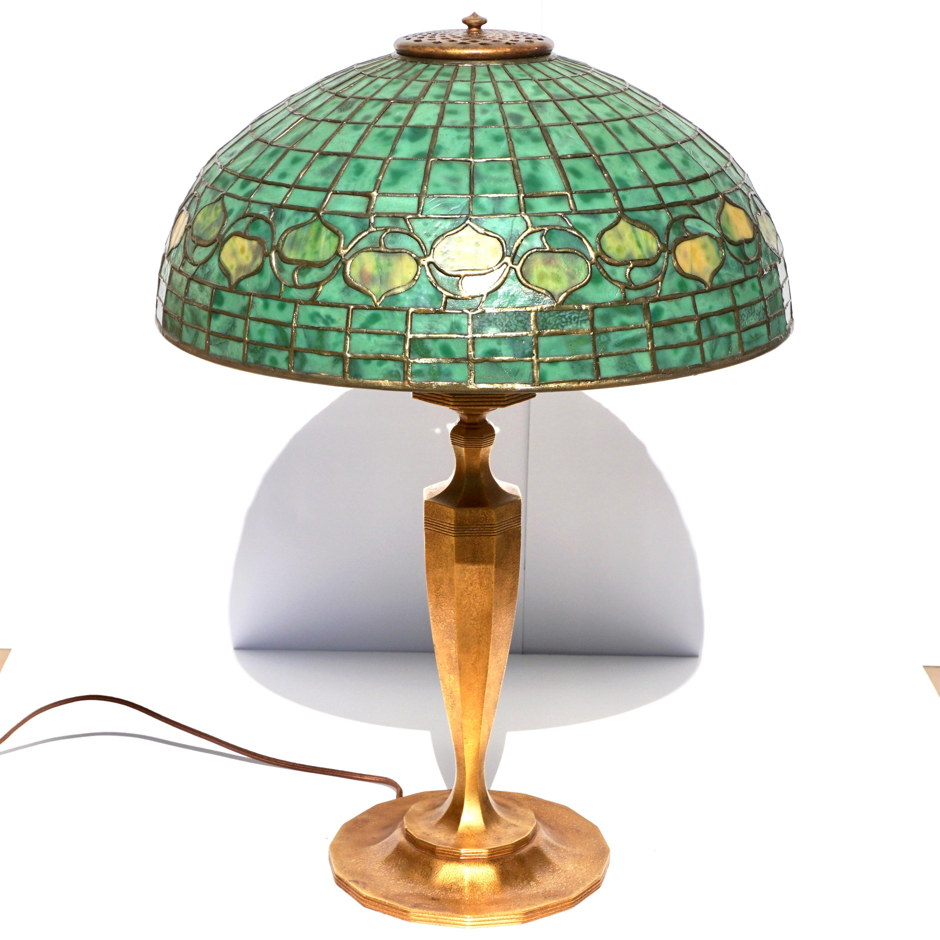 Tiffany studios New York acorn and bronze Art Nouveau table lamp. Circa 1910

A beautiful Tiffany Studios green acorn table lamp in close to perfect condition to grace any room in your house or office. The base is textured in gilt gold with a Art