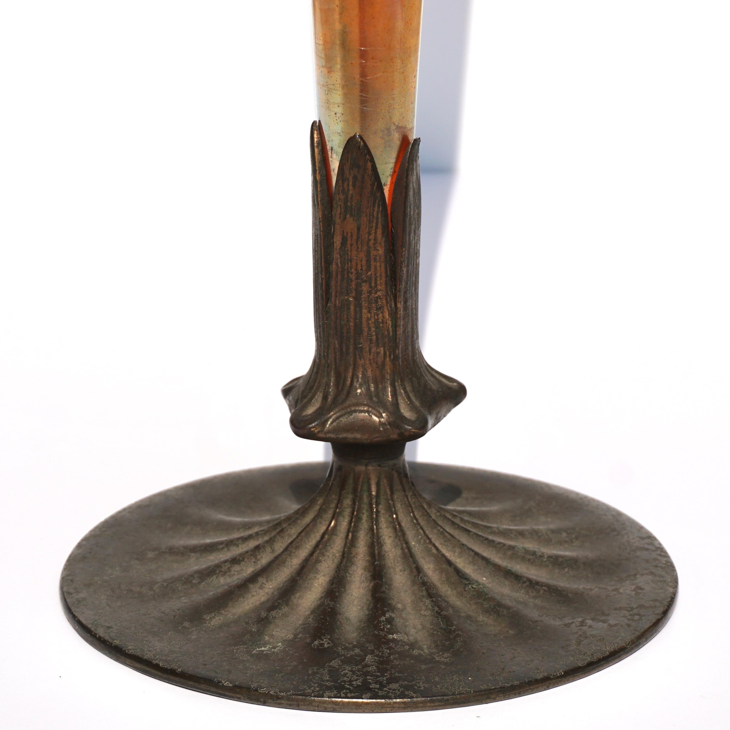 Tiffany Studios and Louis Comfort Tiffany Lily Vase

A tall Favrile glass vase by Tiffany Studios with bronze base standing an impressive 18 Inches tall. The trumpet shaped Favrile glass vase features gold favrileglass with pink and purple