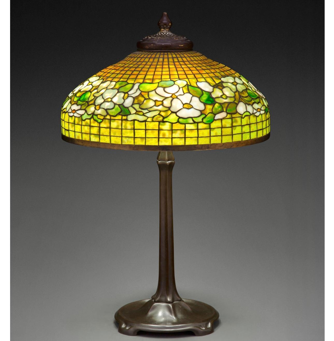 A large Tiffany Studios leaded glass and patinated bronze banded dogwood table lamp, circa 1910
The 20.5 Inch diameter shade dominates a room and gives ample light to be the center piece and the center of conversation. The Tiffany Studios patinated
