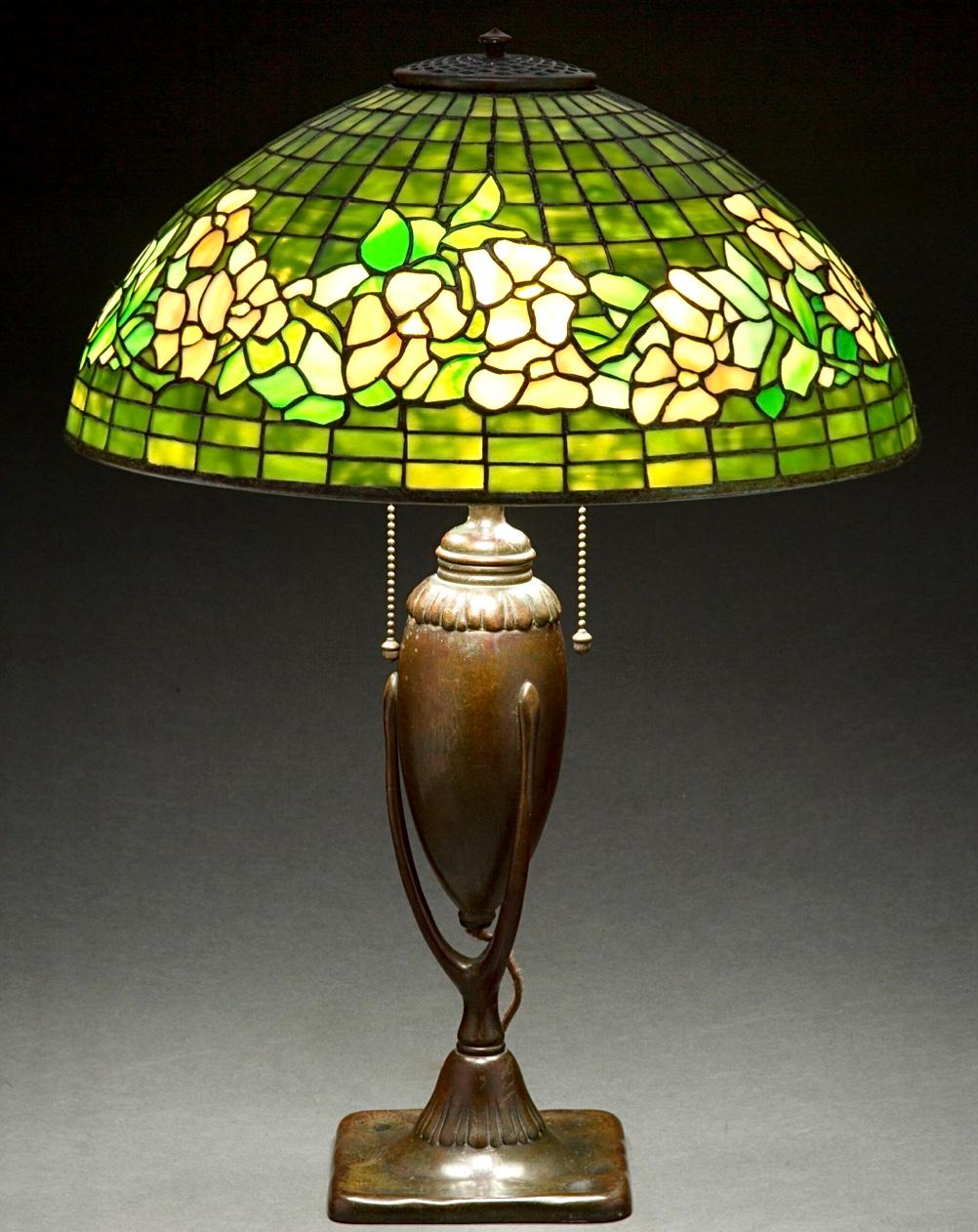 Tiffany Studios Leaded glass and patinated bronze banded Dogwood table lamp, circa 1910 Art Nouveau Art Deco. 

A beautiful example of Art Nouveau era Florian and geometric hand crafted leaded glass lighting. The shade with a rare lime green,