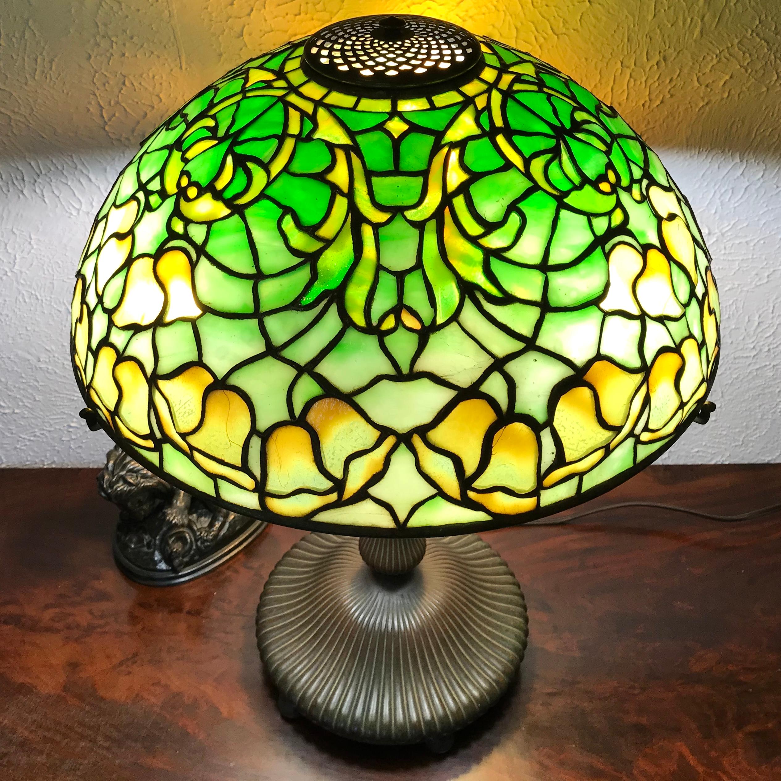 Tiffany Studios New York, circa 1905 Art Nouveau floral table lamp. Leaded art glass floral shade and patinated bronze base.

This lamp is absolutely wonderful with its rich realistic colors and beautiful design. It glows and lights up any living