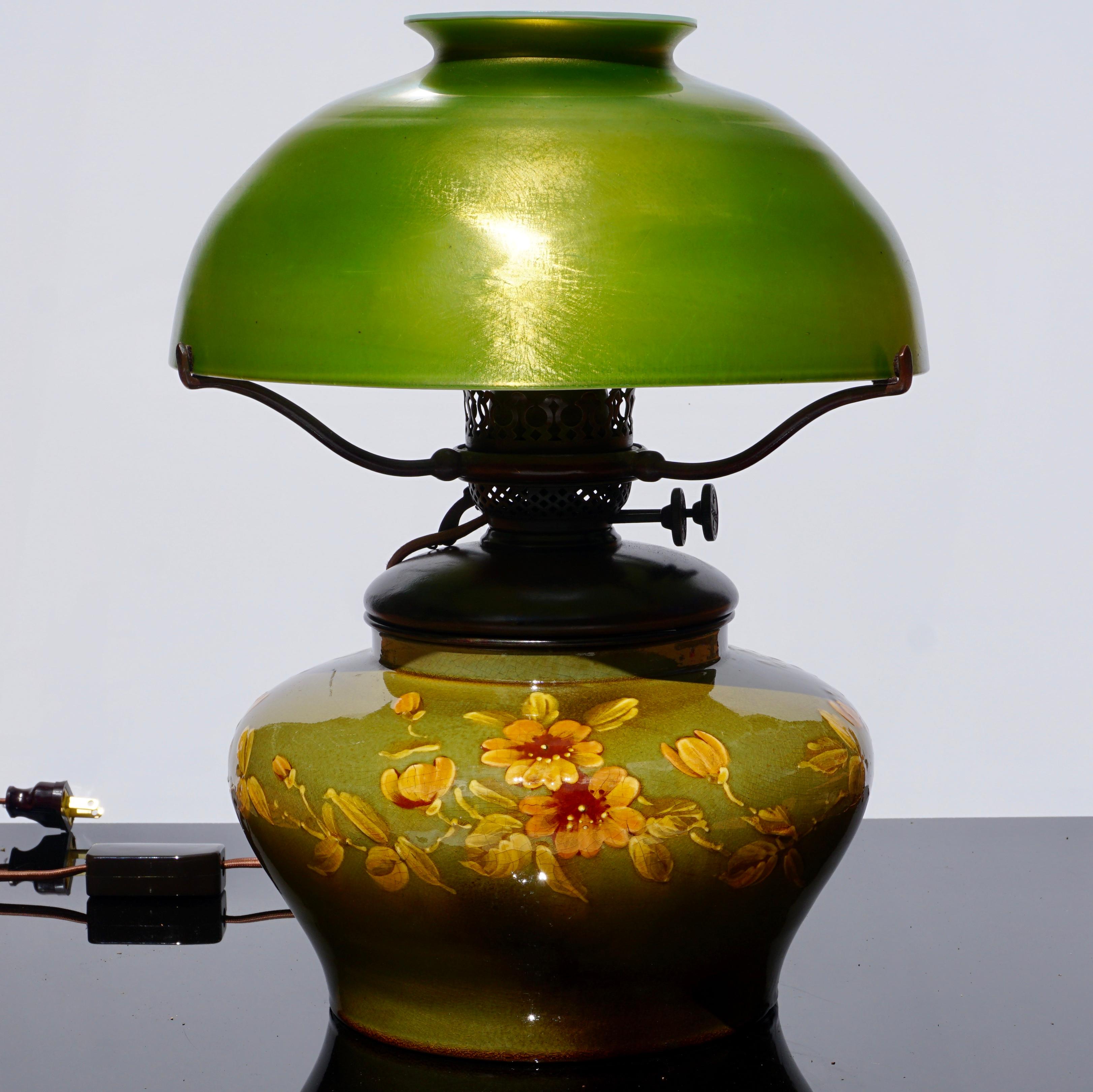 Tiffany Studios favrile and pottery table lamp, circa 1900

This lamp is absolutely beautiful!  The green favrile Damascene glass shade is stunning at 12 Inches Diameter and was made for the gorgeous pottery base. Note: Interior of shade has glass