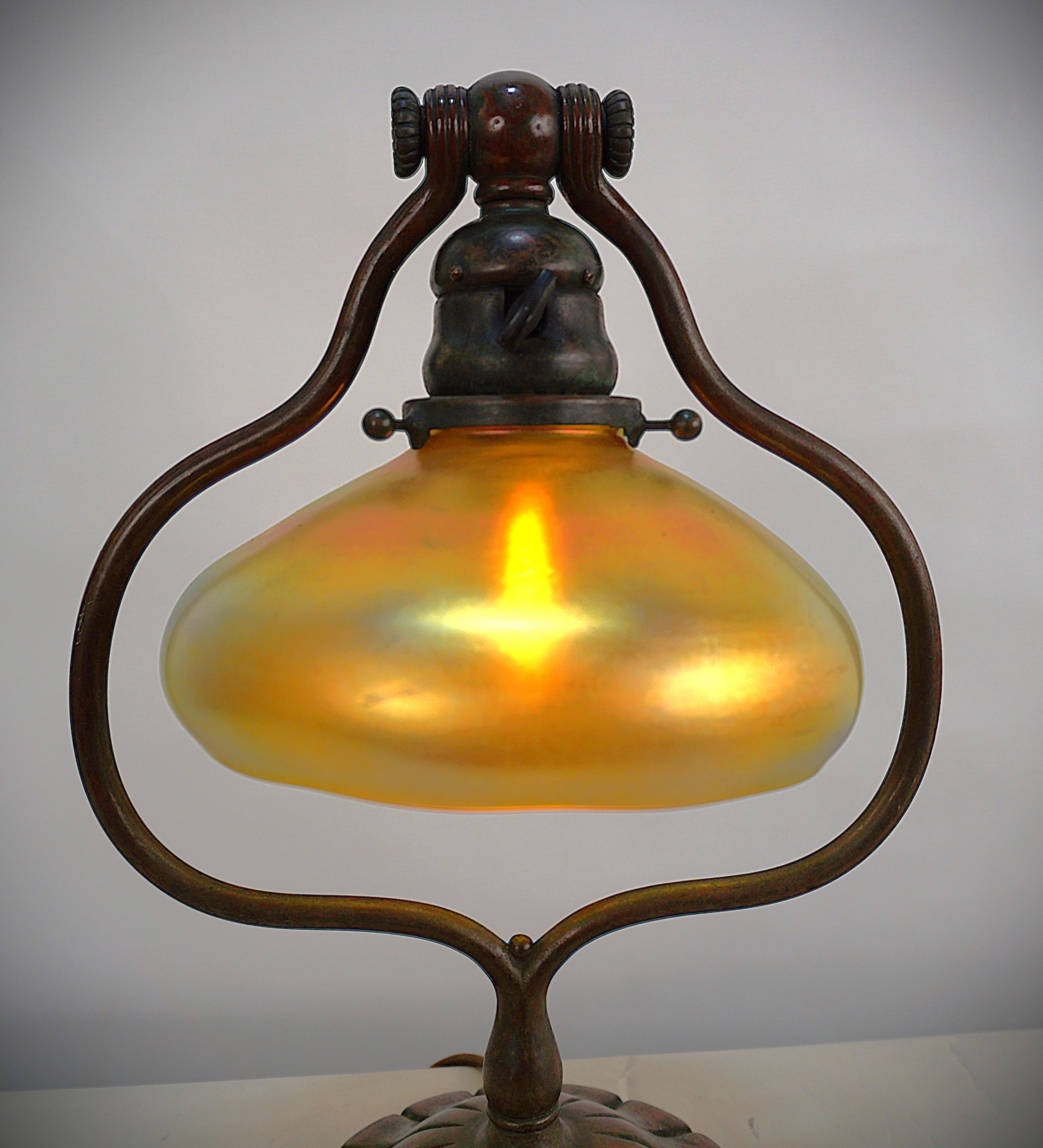 Tiffany Studios Bronze harp shape desk/table lamp with beautiful iridescent gold shade.
Marked Tiffany Studios New York