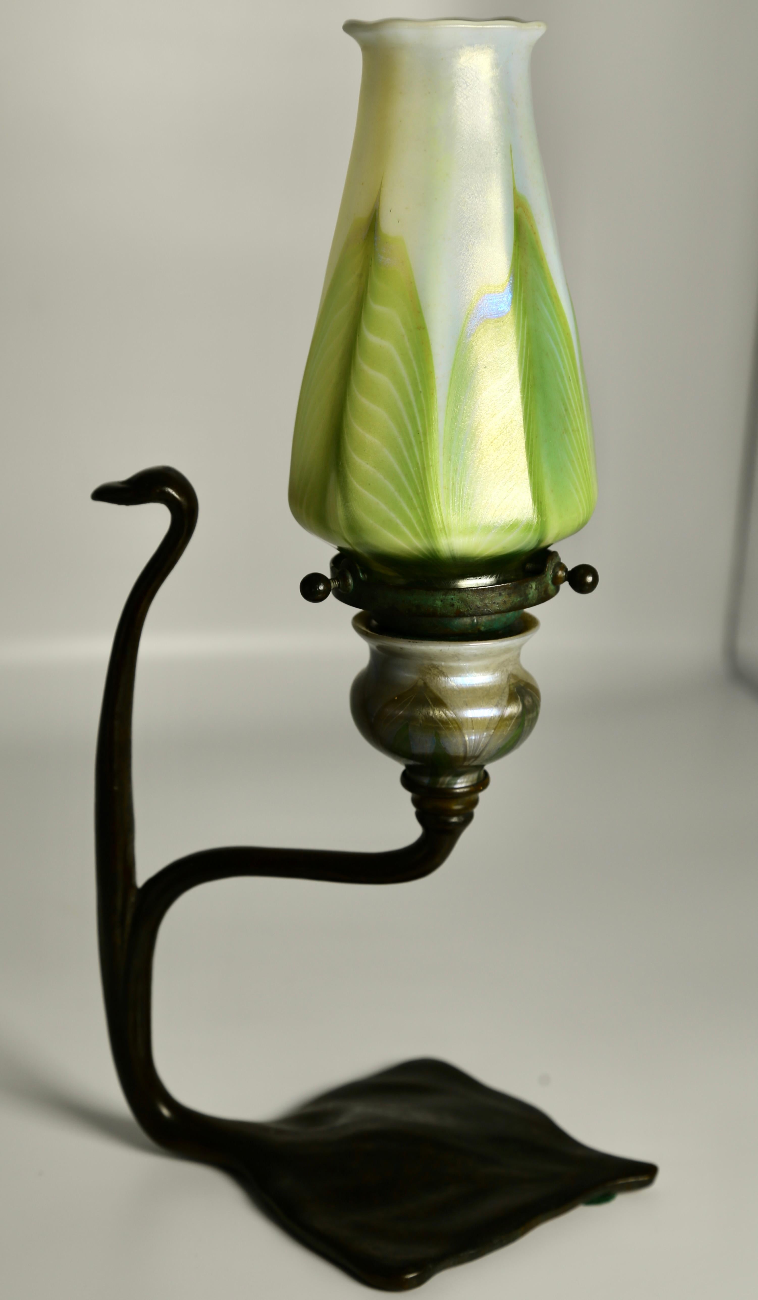 Tiffany Studios ‘Cobra’ Candlestick made of Bronze with Tiffany Iridescent Favrile Glass ‘Pulled Feather’ Shade circa 1905-1910.

Iconic example of legendary Tiffany design and craftsmanship this Tiffany Studios ‘Cobra’ Candlestick incorporates a