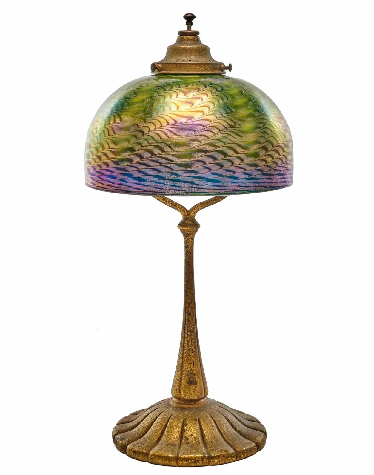 Tiffany Studios New York Table Lamp

This Damascene shade has exceptional blue and green iridescence and is in pristine condition. The textured and gilt base in wonderful original condition with a brilliant finial switch (Original)

New York,