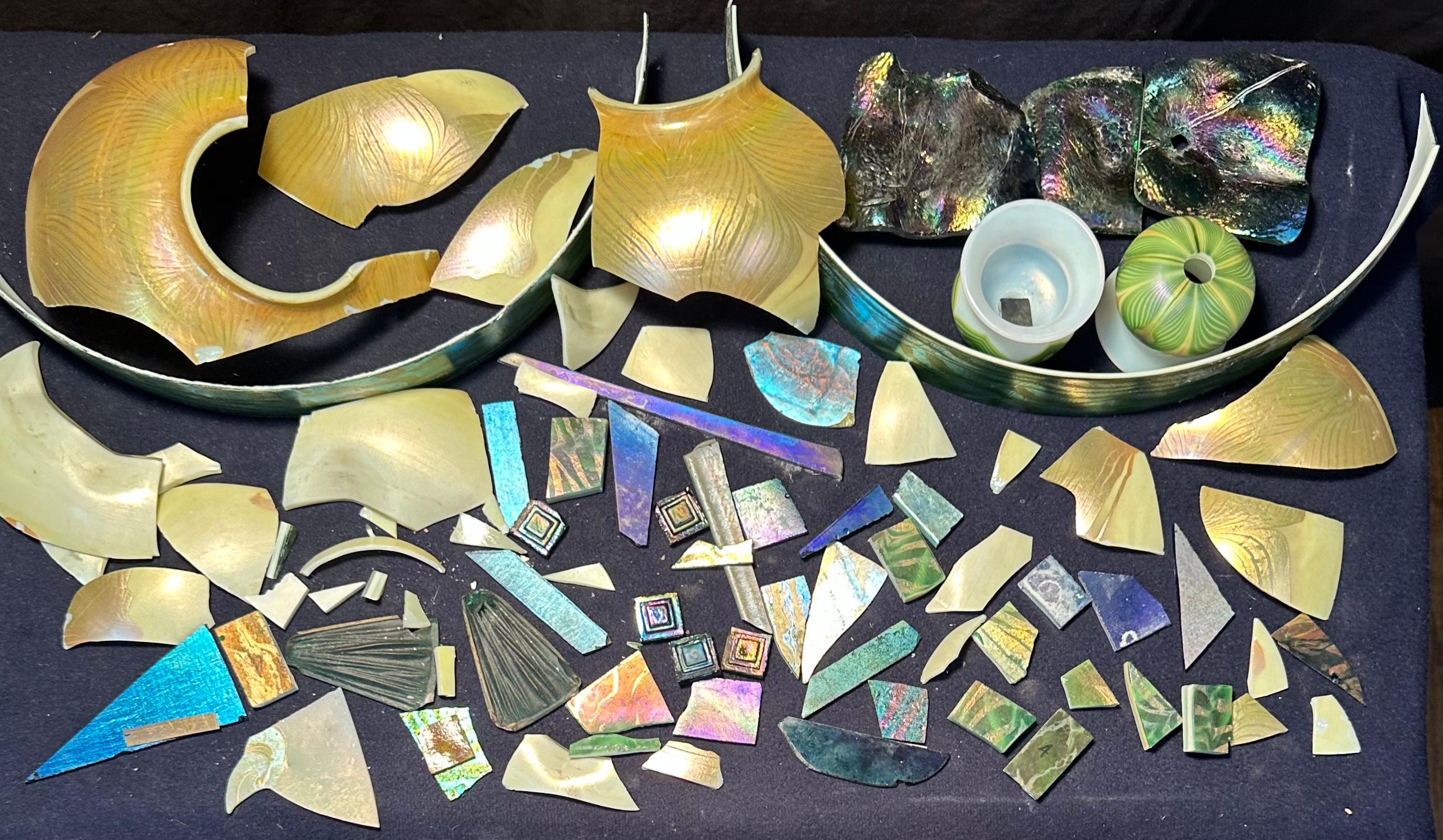 This early 20th century collection of favrile art glass fragments originated at the Tiffany Studios, New York. It consists of numerous pieces of favrile art glass fragments in various shapes, sizes & colors. This assortment of favrile glass can be