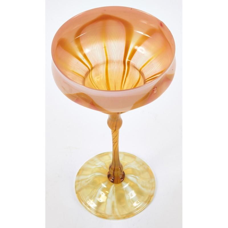 A Favrile flower form vase by Louis Comfort Tiffany featuring a pulled feather design in tones and hues of pink, yellow and white. 

Favrile glass vases in the shapes of stylized flowers were among the earliest creations of the Tiffany Glass and