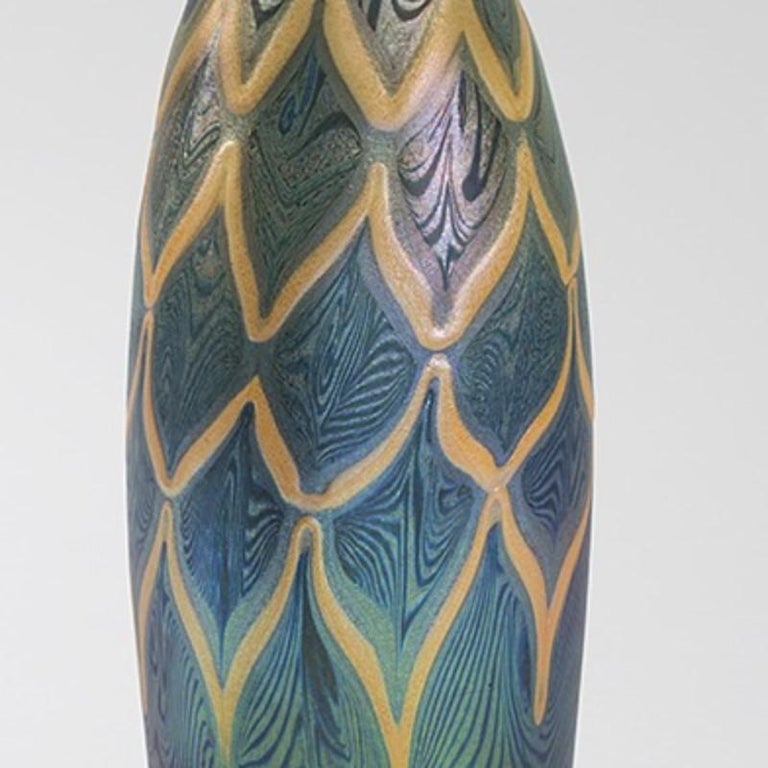 A Favrile glass vase by Tiffany Studios New York. The vase has a background of iridescent medium and turquoise blue swirls that is overlaid with thick opaque pink geometric decoration, circa 1895.

Signed, ''L.C.T. D785''. 

     