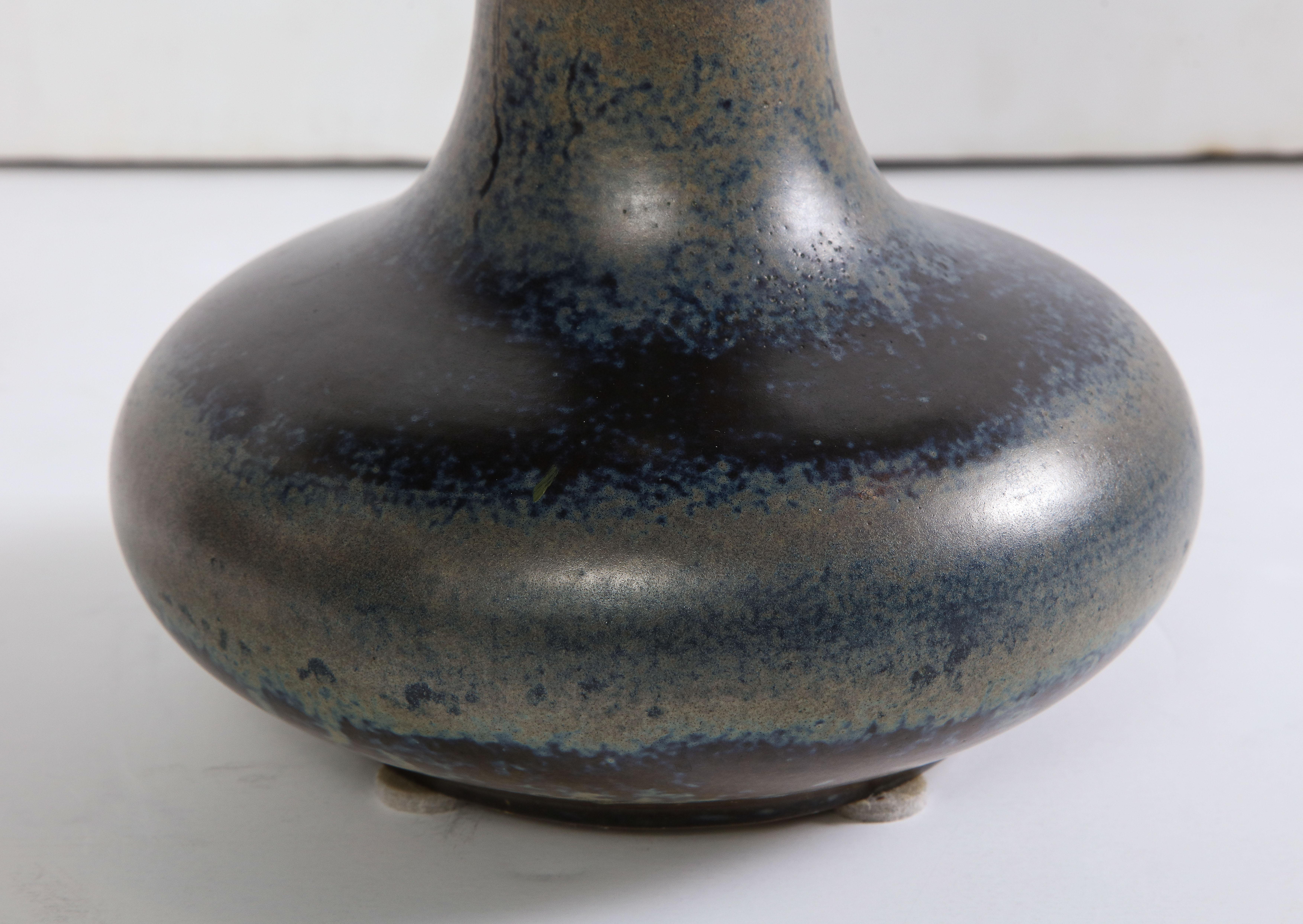 Of trumpet form with a mottled blue glaze, inscribed signature.
 