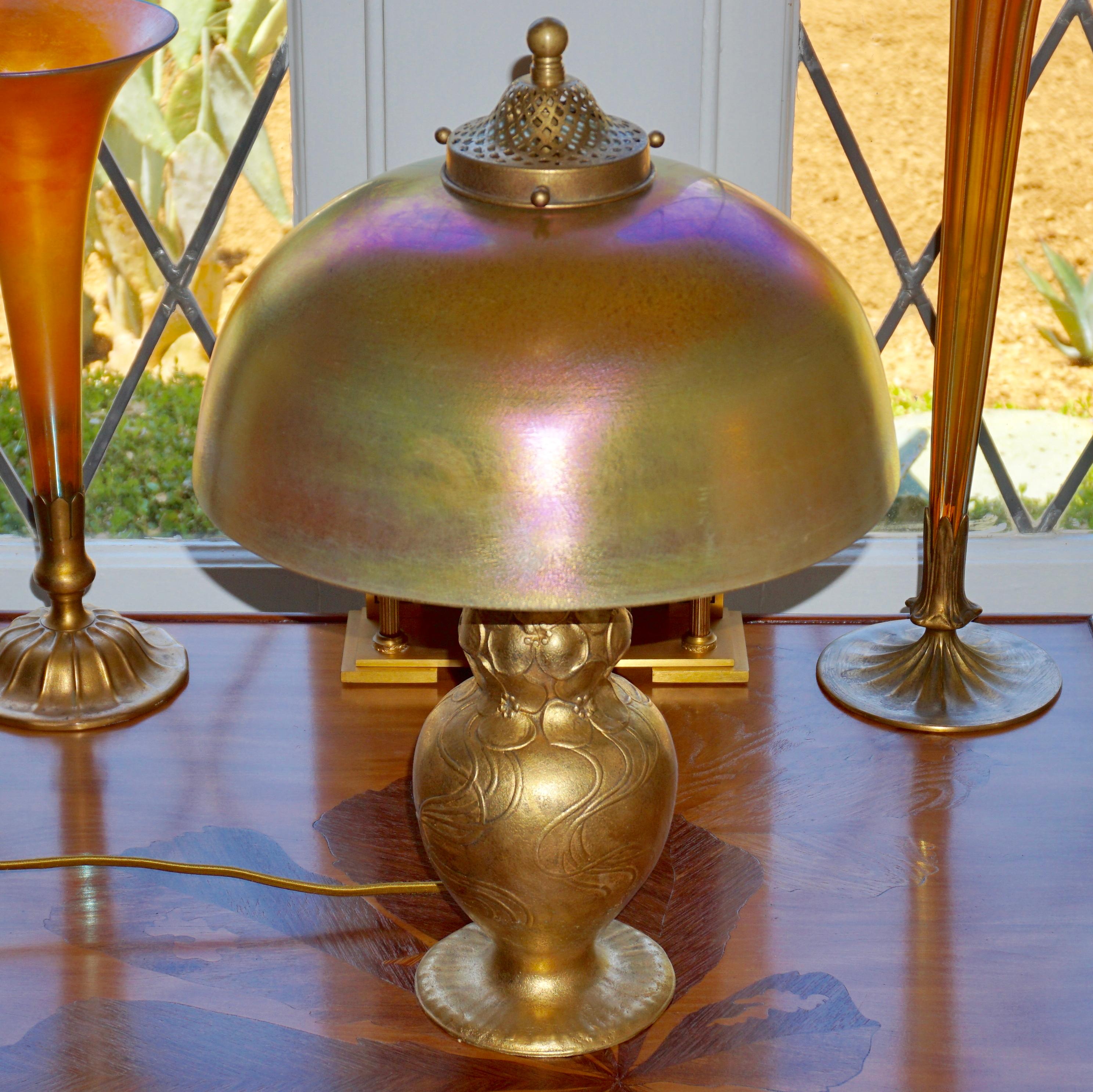 Tiffany Studios gold gilt bronze and favrile table lamp, circa 1910

This lamp will definitely be the center piece in your Library, study, office or living room. What sets this TSNY lamp apart from the rest is its rarity and sculptural beauty. Don’t