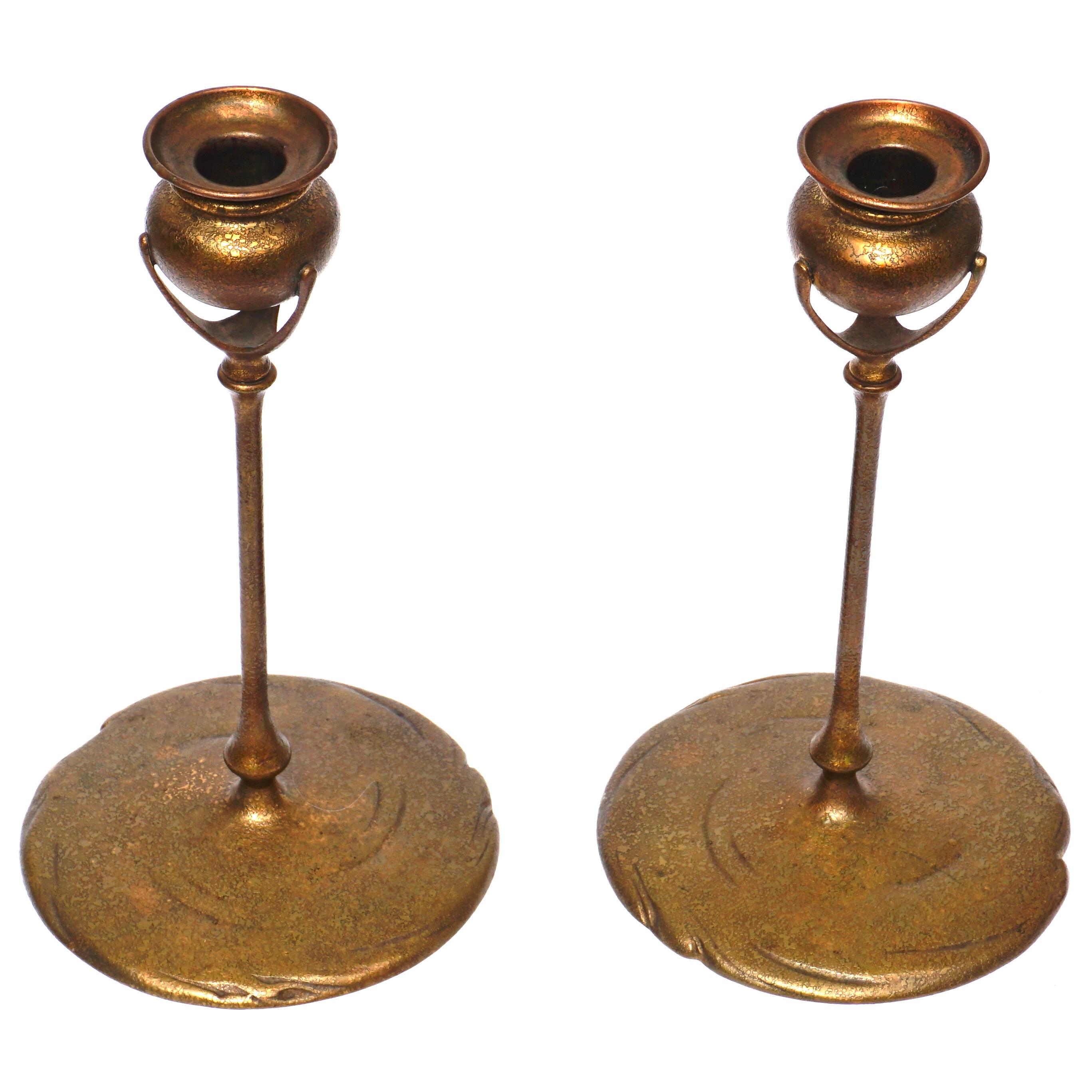 Pair of Tiffany Studios gilt bronze candlesticks, circa 1905 Art Nouveau
Marks: TIFFANY STUDIOS, NEW YORK, 1213 
Measures: Height: 10 inches (25.4 cm) (each), Diameter: 5.75 inches
Condition: Very good with slight rubbing to gilding. Original