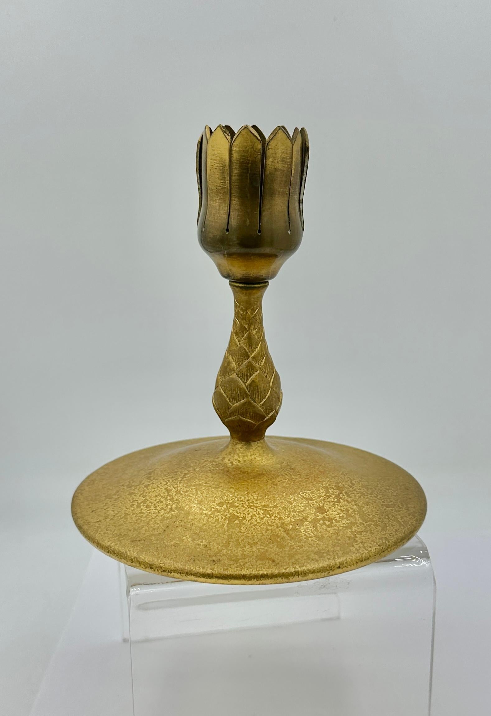 This is an acid-etched Tiffany Studios bronze base for a vase, or it may be used as a candlestick.  It is a standalone candlestick without the glass vase or insert. The tongs that hold a vase in place are in excellent condition, and the bottom is