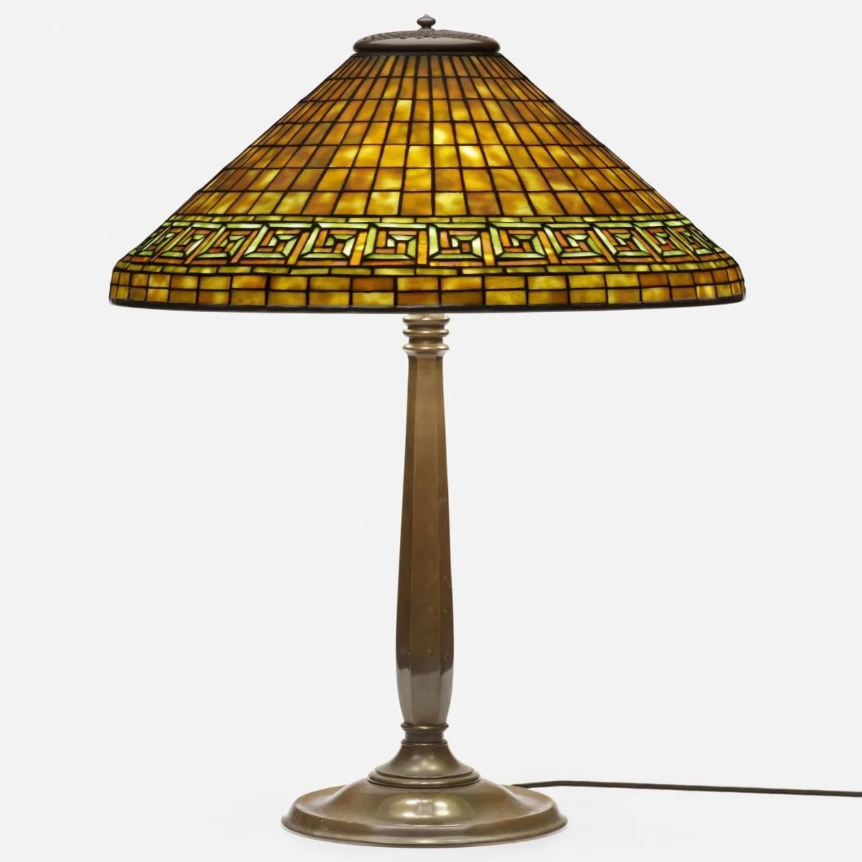 Tiffany Studios Greek key table lamp
New York, USA, circa 1910
leaded glass, patinated bronze
Dimensions: 26 height x 20 diameter in (66 x 51 cm)

Lamp features a Colonial Library Standard base with rich chocolate brown patina and a leaded