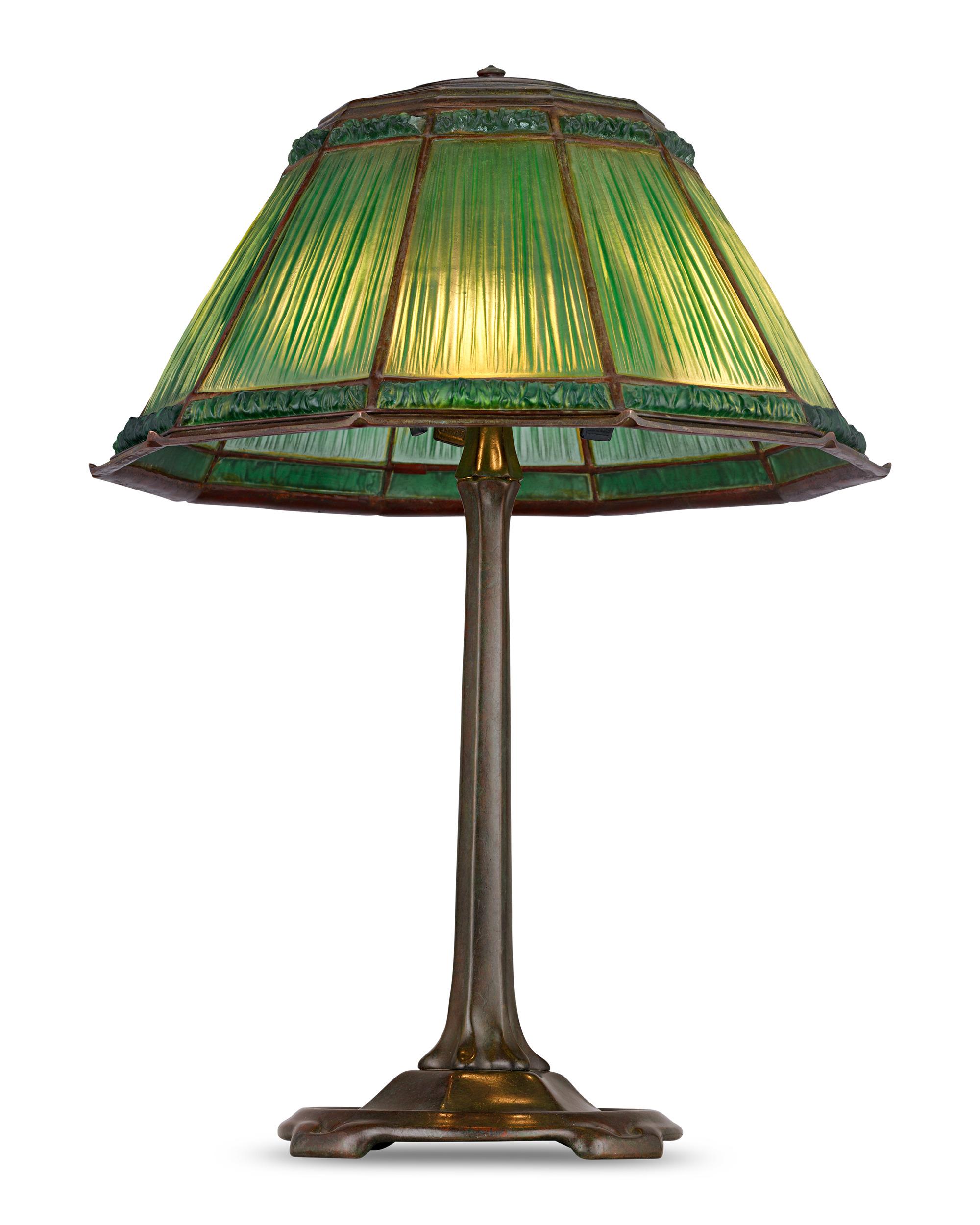 Green Linenfold Lamp
Tiffany Studios
Circa 1915

This Tiffany Studios library lamp features a lush green favrile fabrique shade, also known as the Linenfold pattern. The shade's green-hued glass is beautifully worked into a rippled design, imitating