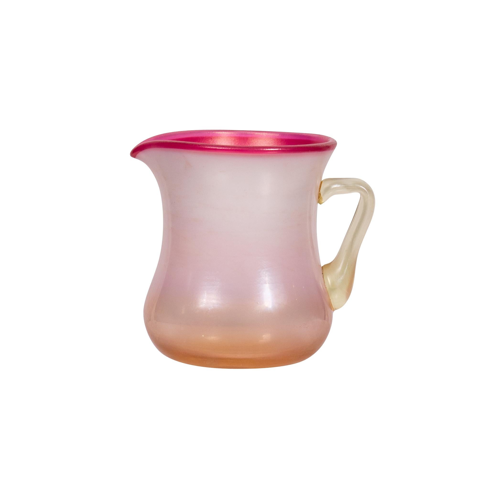 Tiffany Studios
iridescent pink favrile glass small pitcher
circa 1910
engraved 1582 L.C. Tiffany-Favrile
Height 3 1/8 in. (7.8 cm.)
Shipping
Free Shipping Express to Continental US, arrives in 5 to 6 days.
Literature
Alastair Duncan, Louis