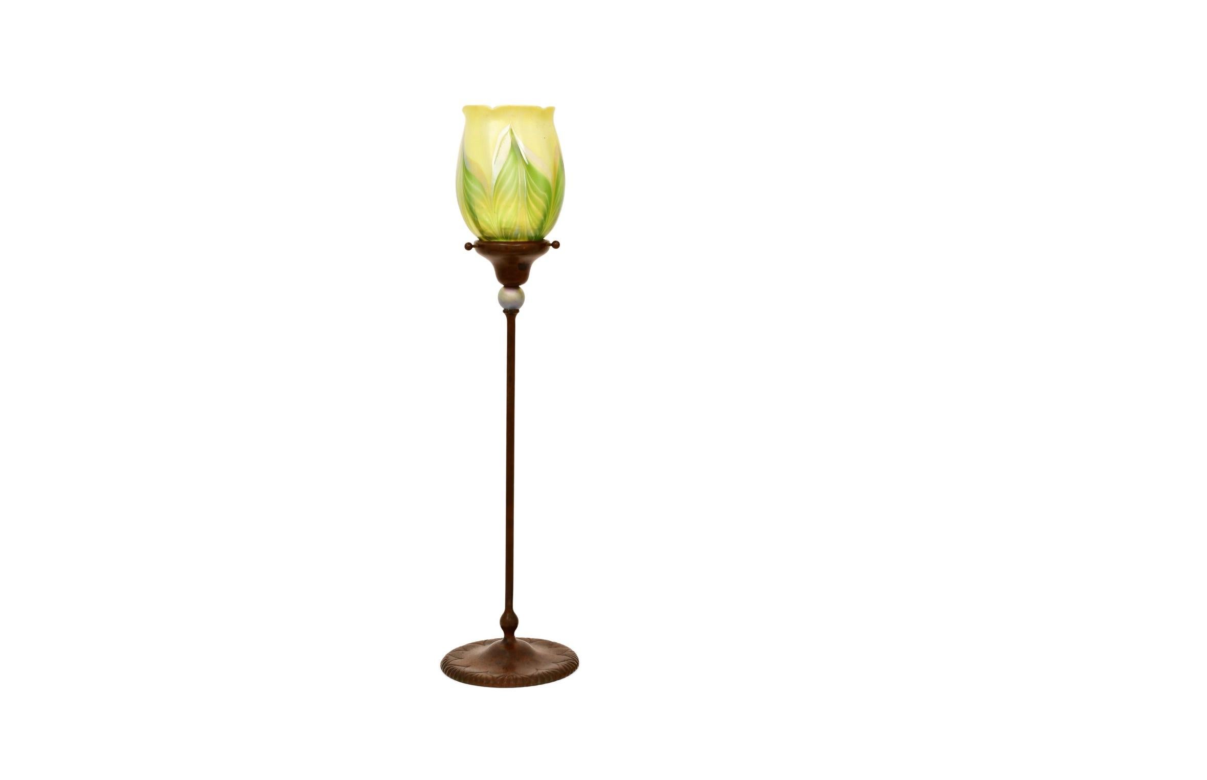 An exceptional example of early 20th-century American design, this tall candlestick lamp by Tiffany Studios, New York showcases the refined artistry and innovation that define the work of Louis Comfort Tiffany. Crafted circa 1910, this piece
