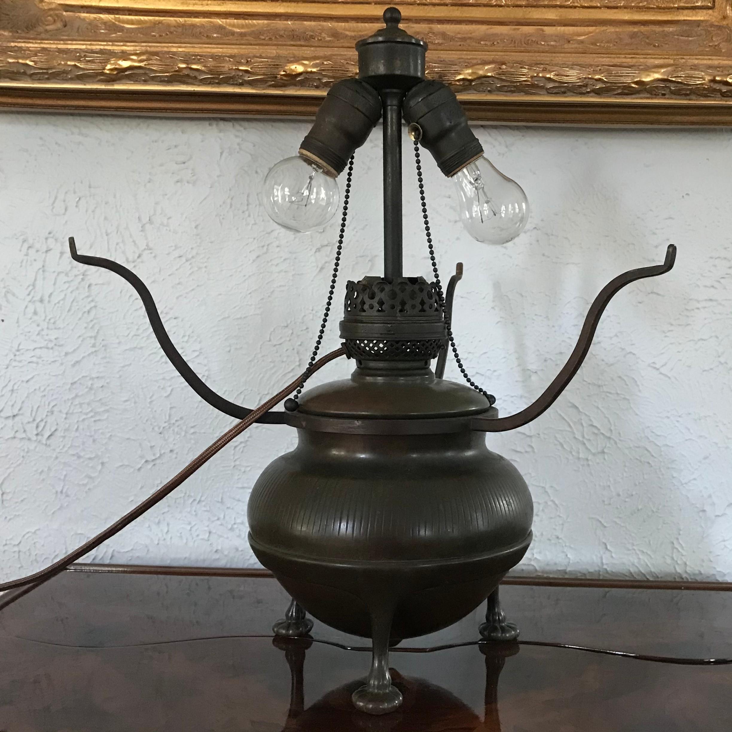 A three pawed bronze acorn oil lamp base with a wonderful brown and red-green patina has need electrified.

Marks to base: TIFFANY STUDIOS, NEW YORK, 25779, (TGD Co. cipher).