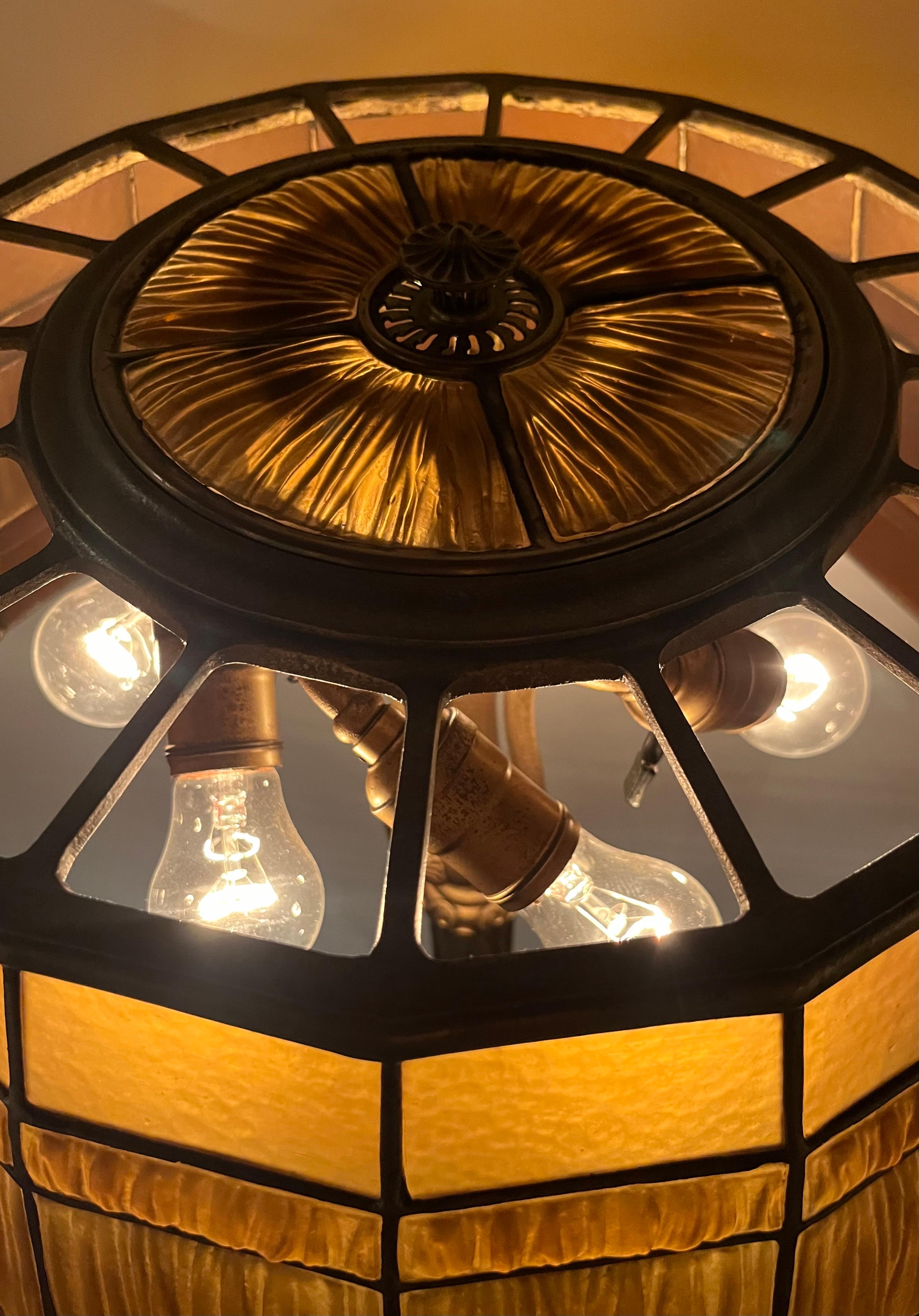 This vintage original Tiffany Studios floor lamp is designed with a paneled “linenfold” gold color shade, signed Tiffany Studios, New York and numbered 1952, Patent applied for.
This shade rests comfortably on a gold dore’ bronze floor base with a