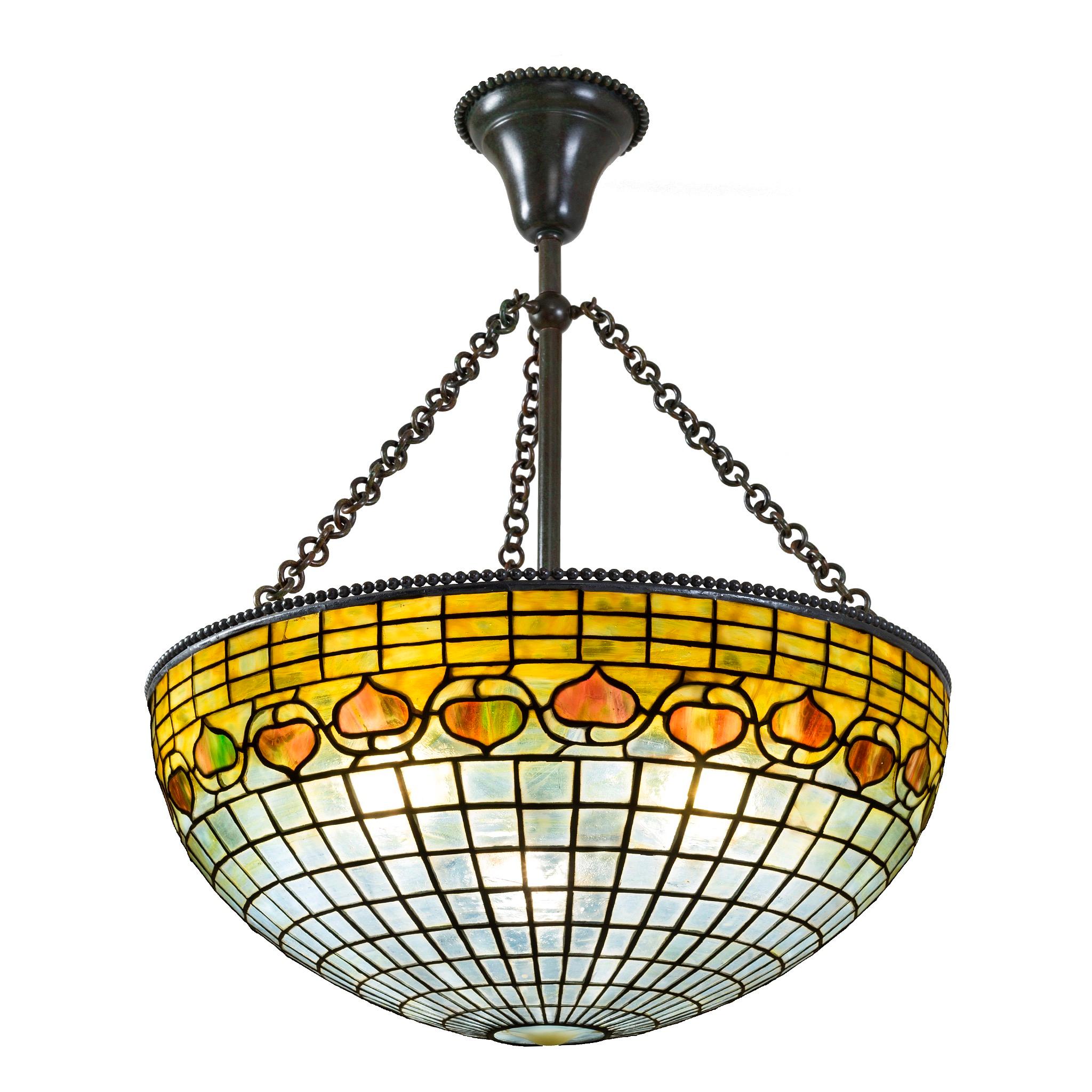 A subtly-colored, full-bodied chandelier from Tiffany Studios New York, decorated with an 