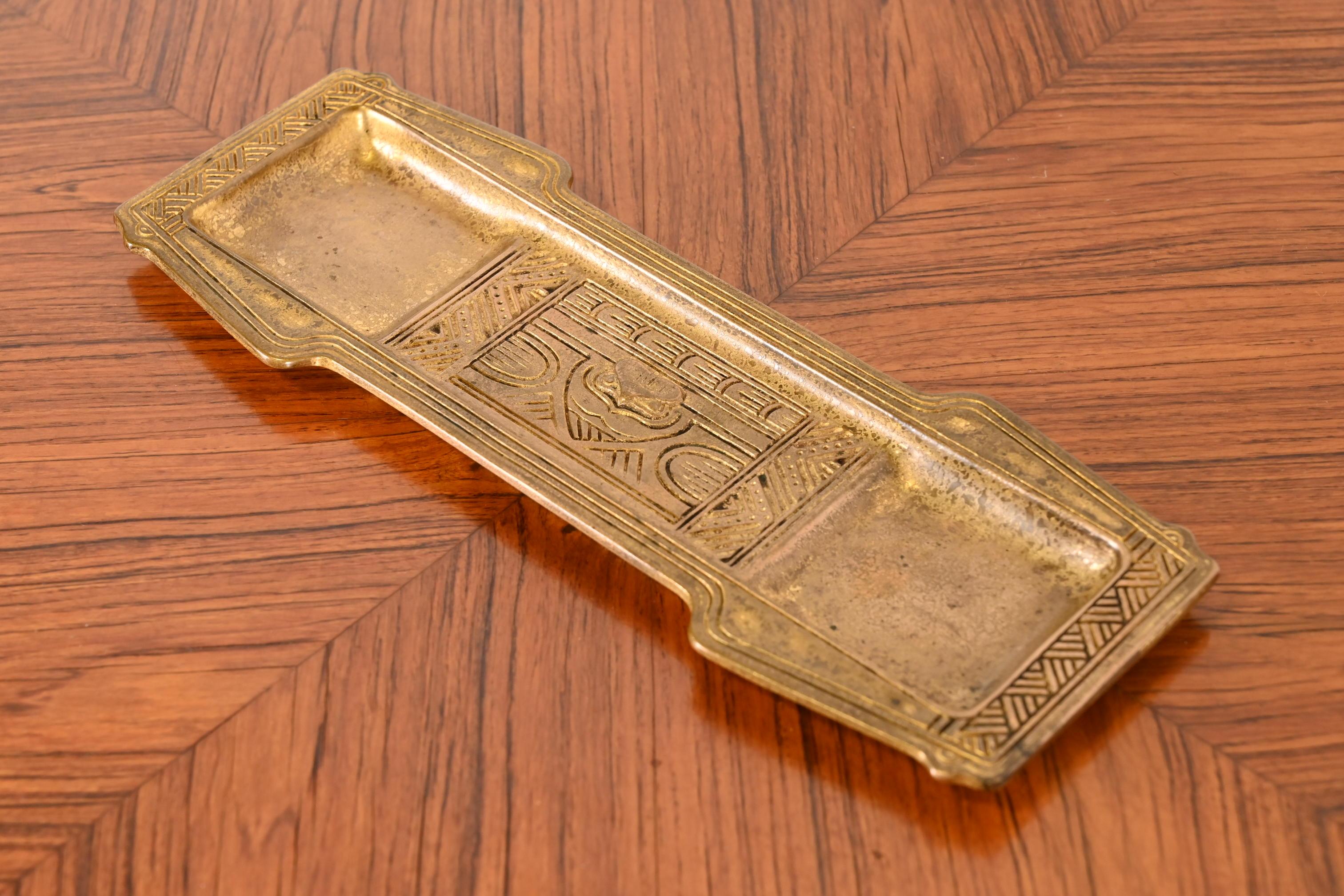 A gorgeous antique Arts & Crafts gilt bronze pen tray featuring Native American design

By Tiffany Studios

New York, USA, Early 20th Century

Measures: 11.13
