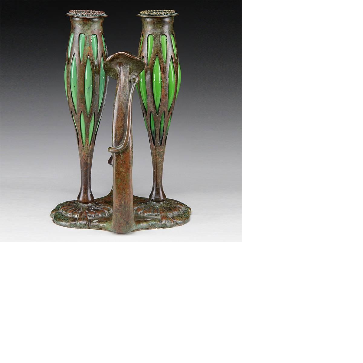 A double blown out glass and patinated bronze candlestick by Tiffany Studios New York. The candlestick features reticulated candle holders with blown-out glass, beaded bobeche tops and tall mushroom bud handle and snuffer stand with a snuffer, circa
