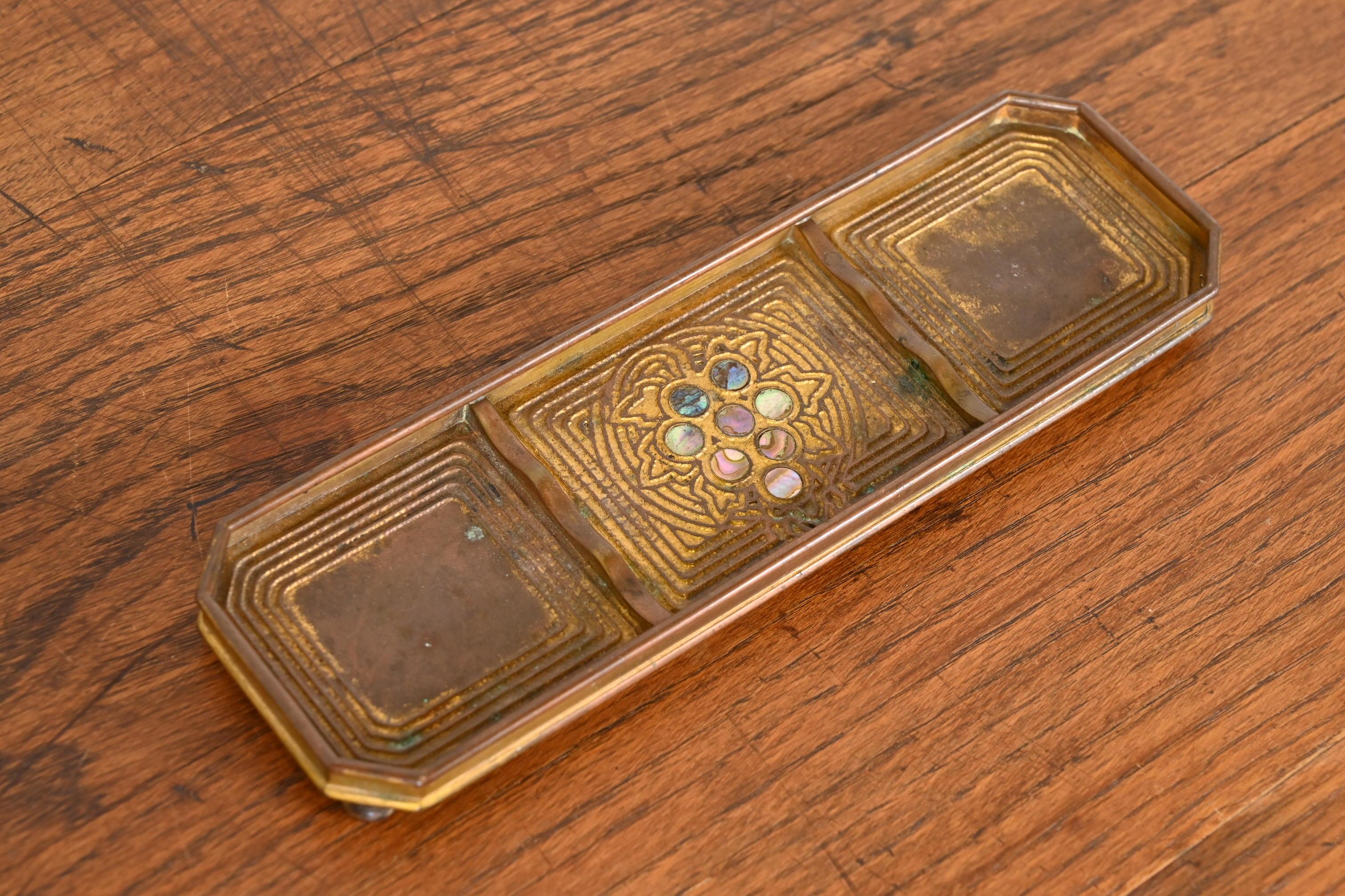 A gorgeous Art Nouveau period gilt bronze and inlaid abalone pen tray

By Tiffany Studios

New York, USA, Early 20th Century

Measures: 8.75