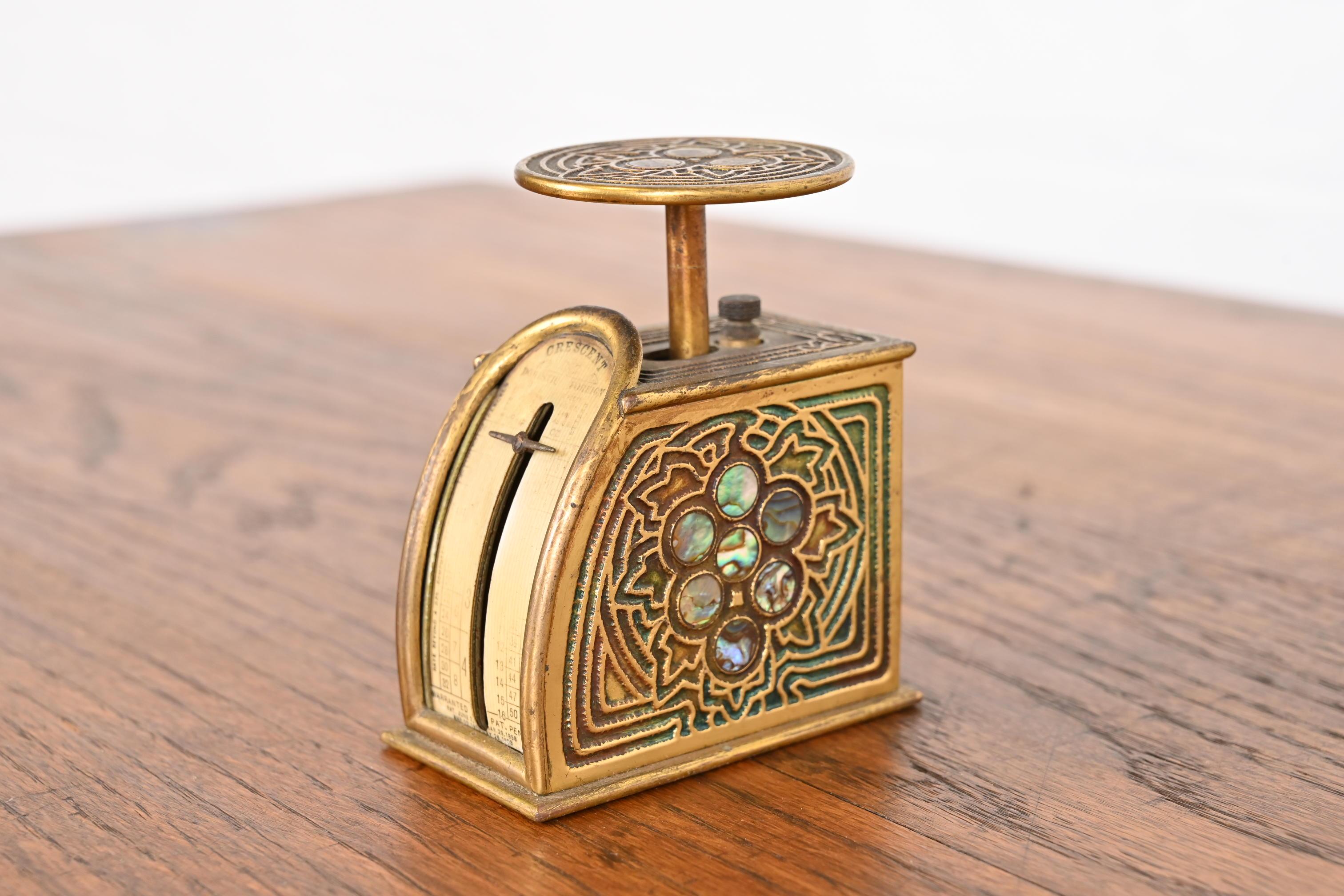 A gorgeous Art Nouveau or Art Deco period gilt bronze and inlaid abalone postage scale

By Tiffany Studios

New York, USA, Early 20th Century

Measures: 1.63