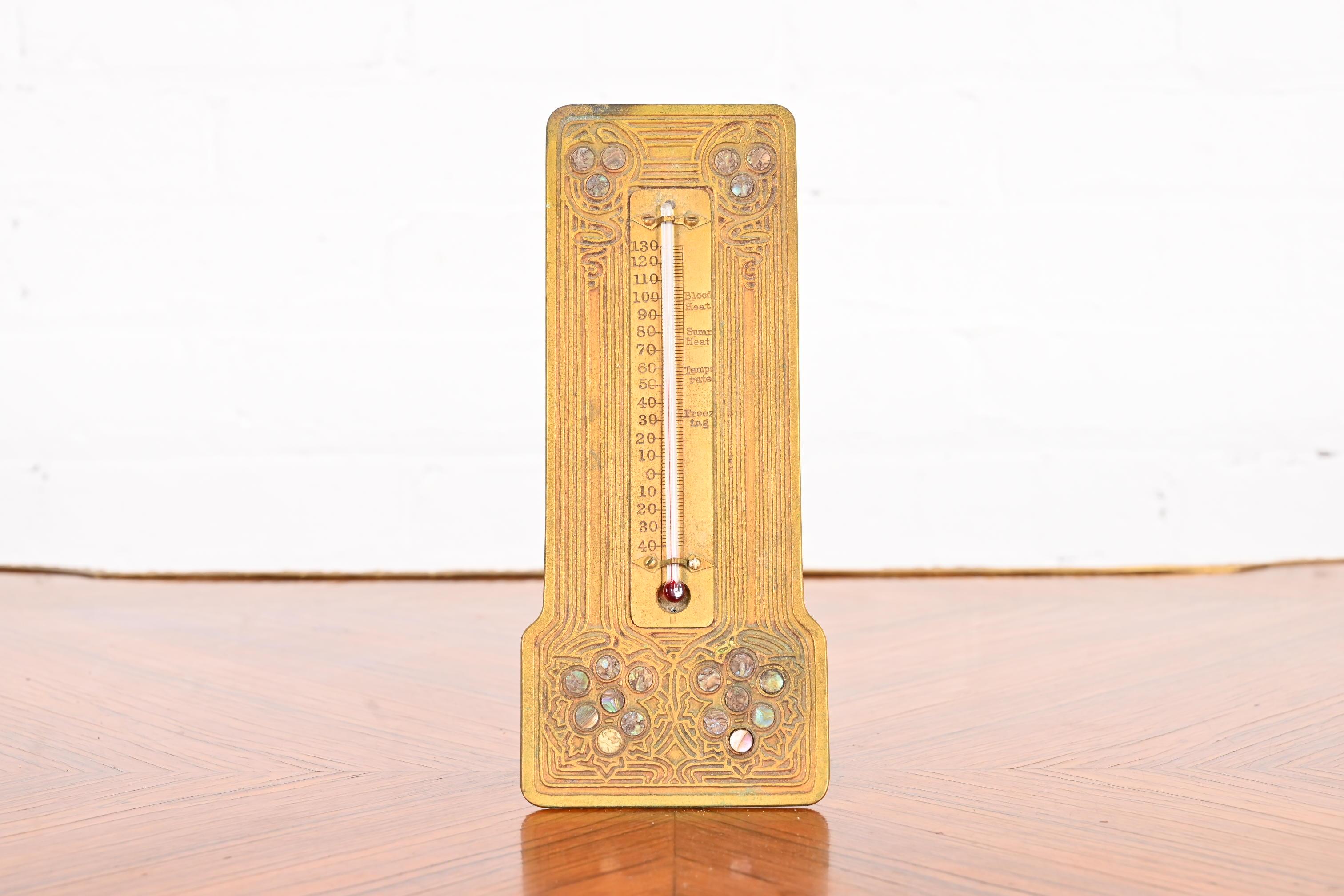 A gorgeous Art Deco period bronze doré and inlaid abalone thermometer

By Tiffany Studios

New York, USA, early 20th century

Measures: 3.75