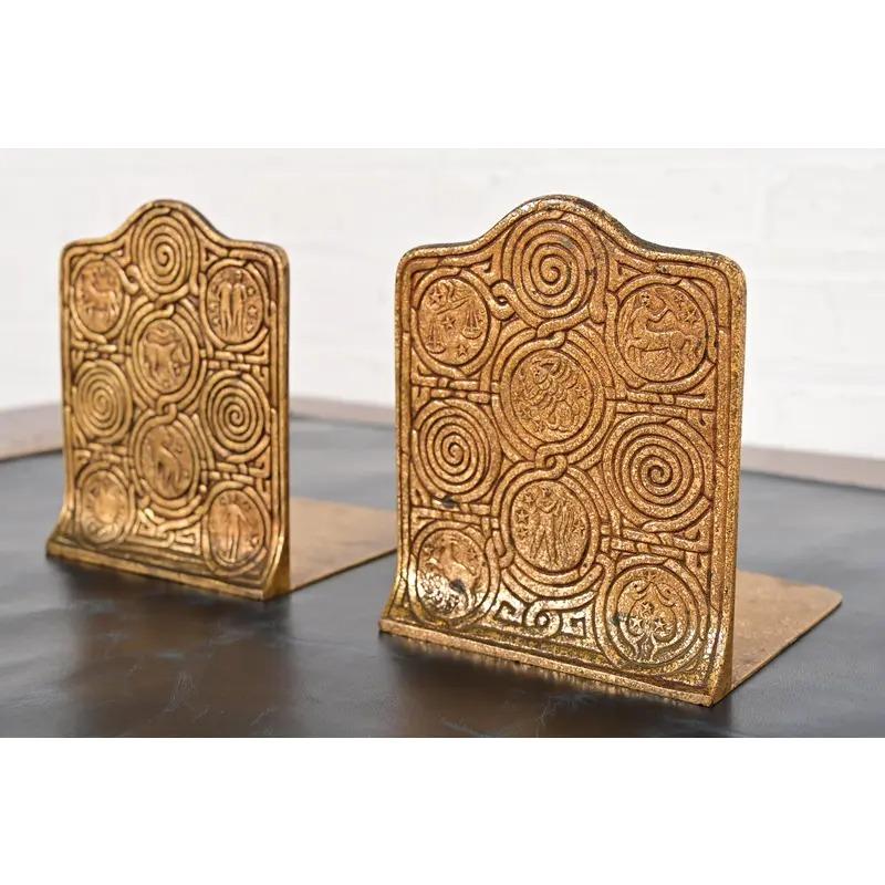 A gorgeous pair of Arts & Crafts or Art Deco period gilt bronze bookends featuring Zodiac designs

By Tiffany Studios (signed on the base)

New York, USA, Early 20th century

Each measures: 5