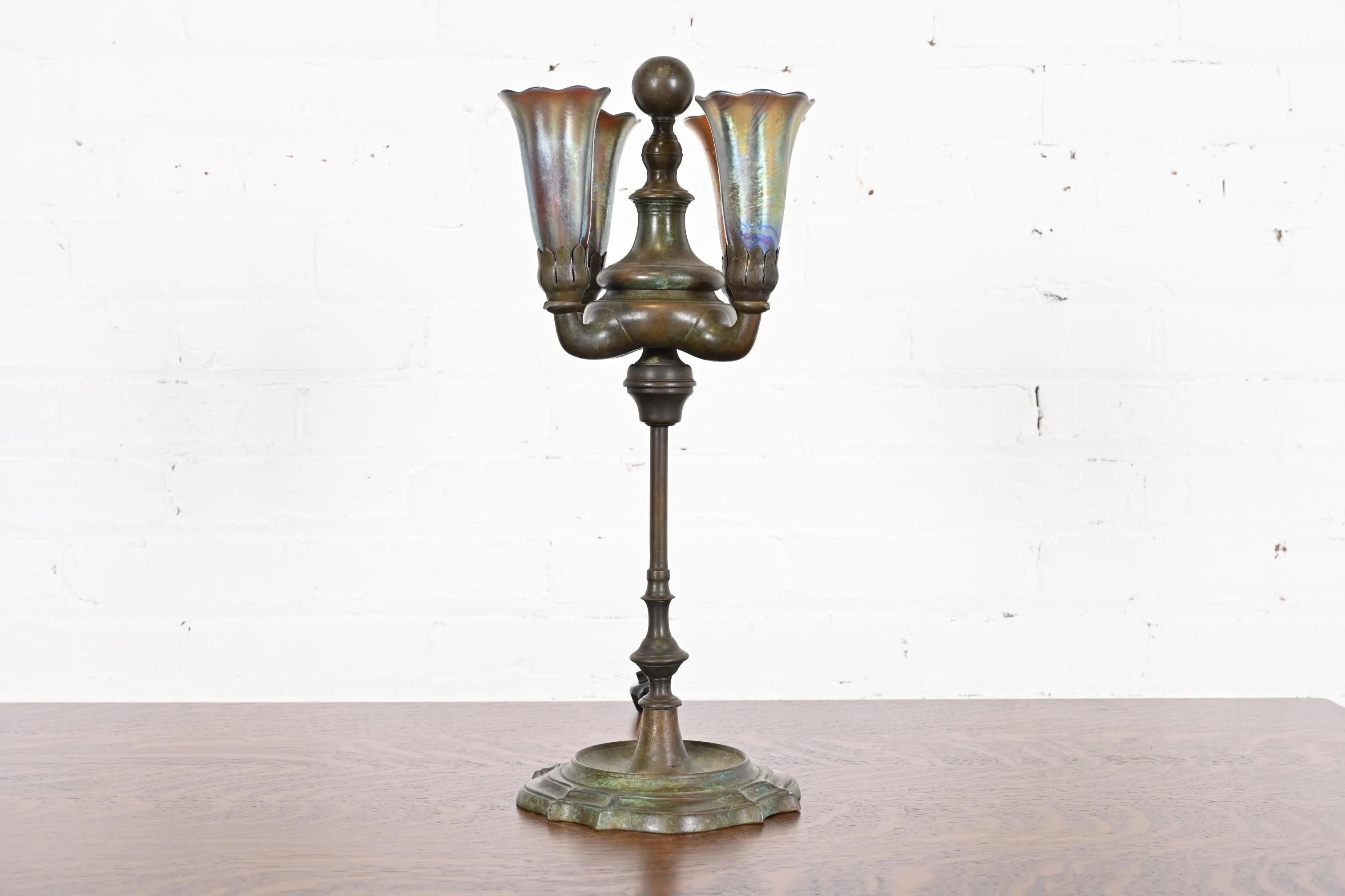 An outstanding Arts & Crafts or Art Deco period four-light table lamp

By Tiffany Studios

New York, USA, Early 20th Century

Patinated bronze, with gorgeous favrile glass shades.

Measures: 7