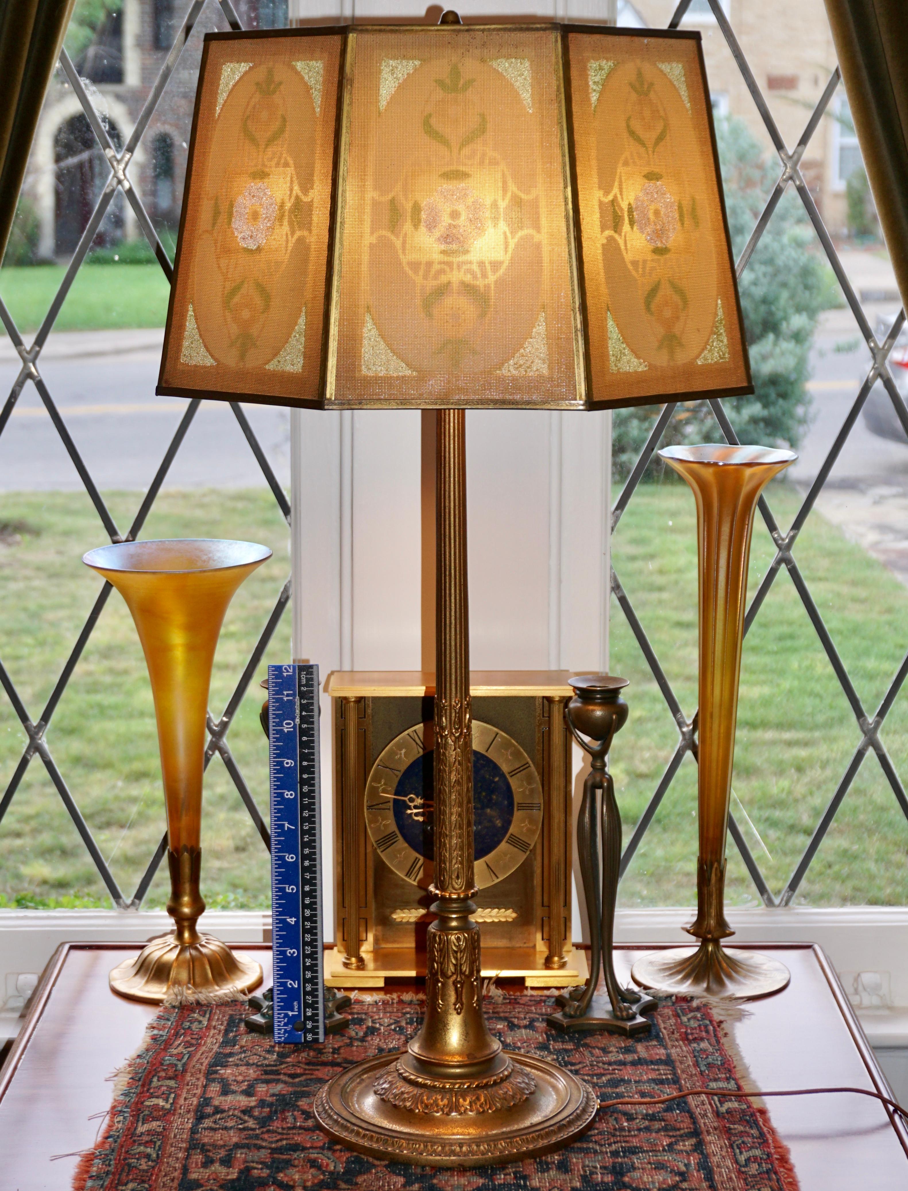 Tall Tiffany Studios four light gilt bronze table lamp with original shade, 

circa 1920. Art Nouveau Art Deco transition with Neoclassical design.

Stamped Tiffany Studios, NEW YORK, 955

Measures: Base height: 31-5/8 inches x 8.5 inches