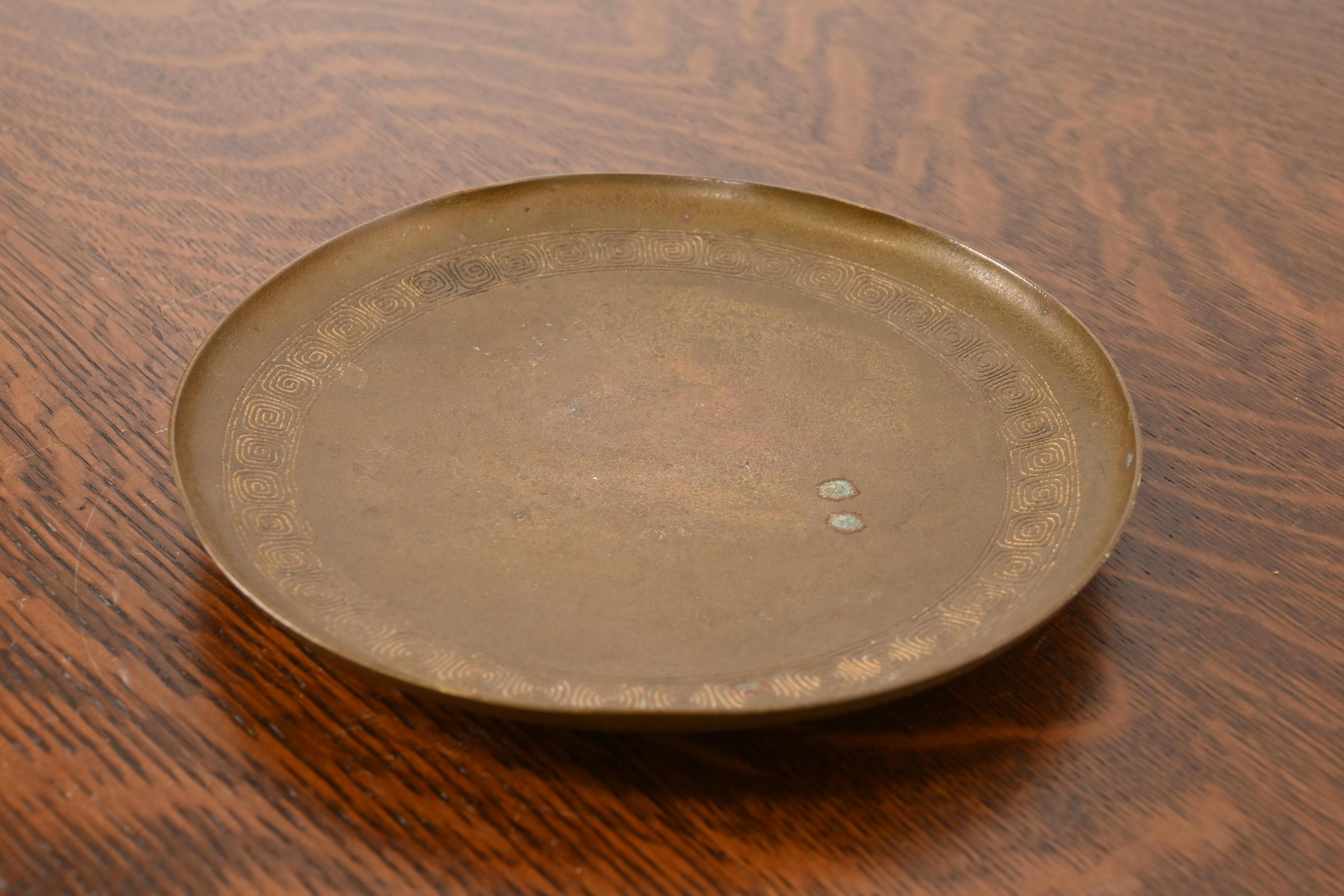 A gorgeous Arts & Crafts or Art Deco period bronze charger plate or serving tray with Greek Key design

By Tiffany Studios (signed to the underside)

New York, USA, Early 20th Century

Measures: 8