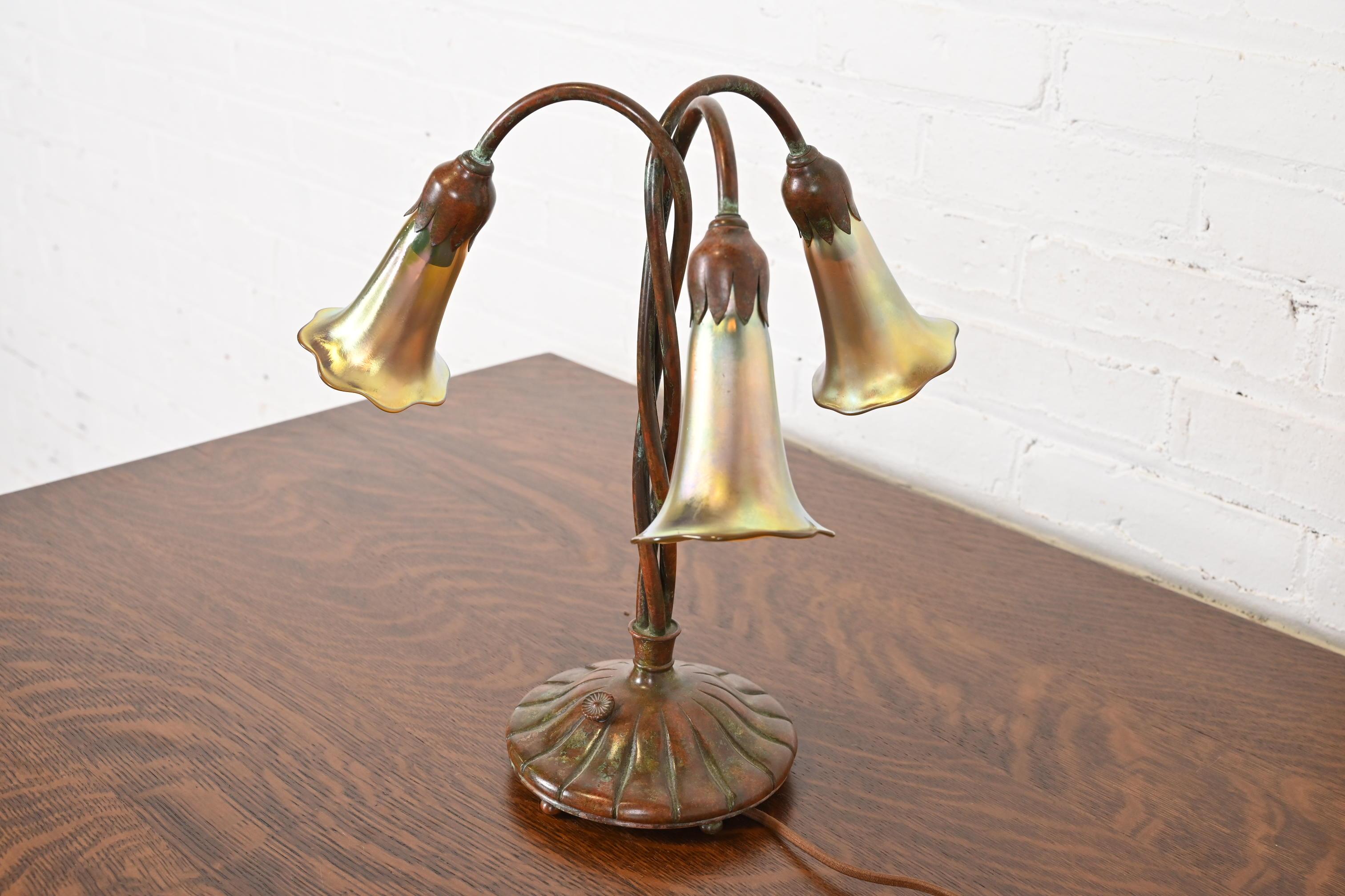 A gorgeous antique Arts & Crafts or Art Deco period bronze three-light 