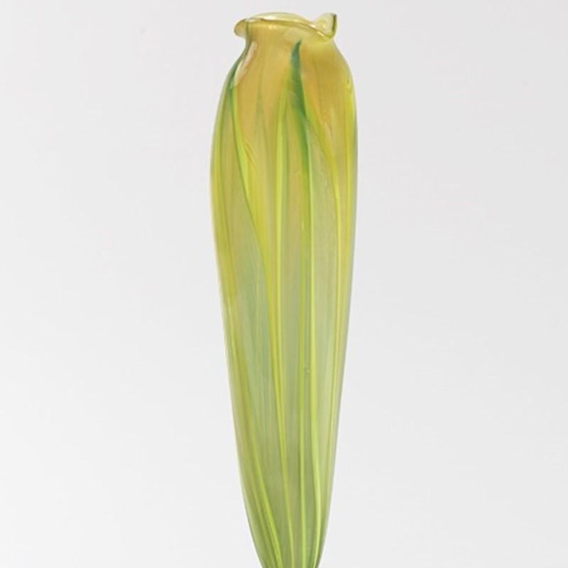 A favrile calyx flower form vase by Tiffany studios New York. 

The flower form vase is meant to suggest the forms, open or closed, of crocus or tulip flowers. The vase is tall and slender and colored with exquisite green and white effects. Here the