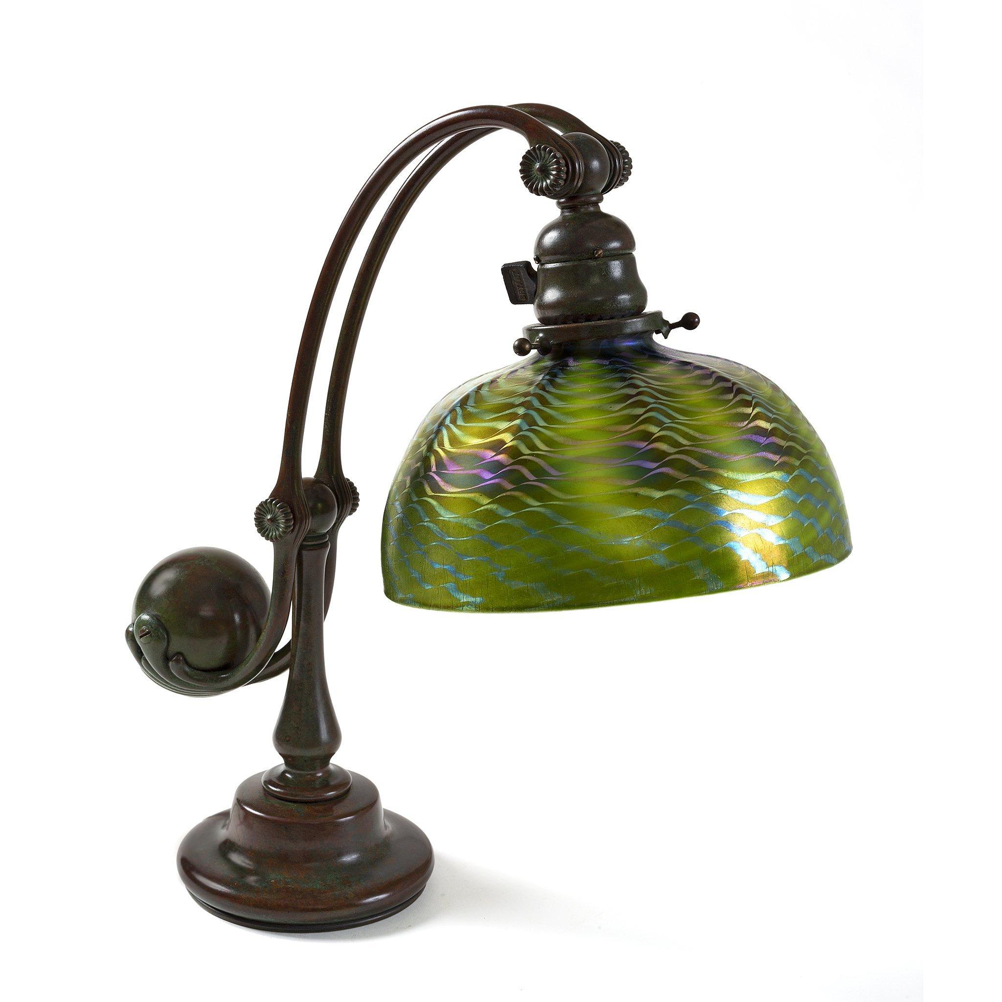 Aptly named, this Tiffany Studios New York “Counter-Balance” desk lamp is a study in elegance and equilibrium. A rotund bronze form of weighty proportions is cradled by two linear rods that support the orb from below before sweeping upward in a