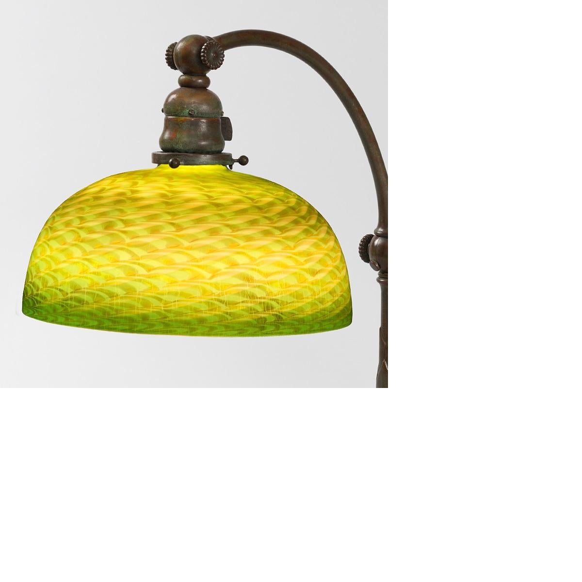 This charming Tiffany Studios New York Favrile glass desk lamp, featuring a bright green 