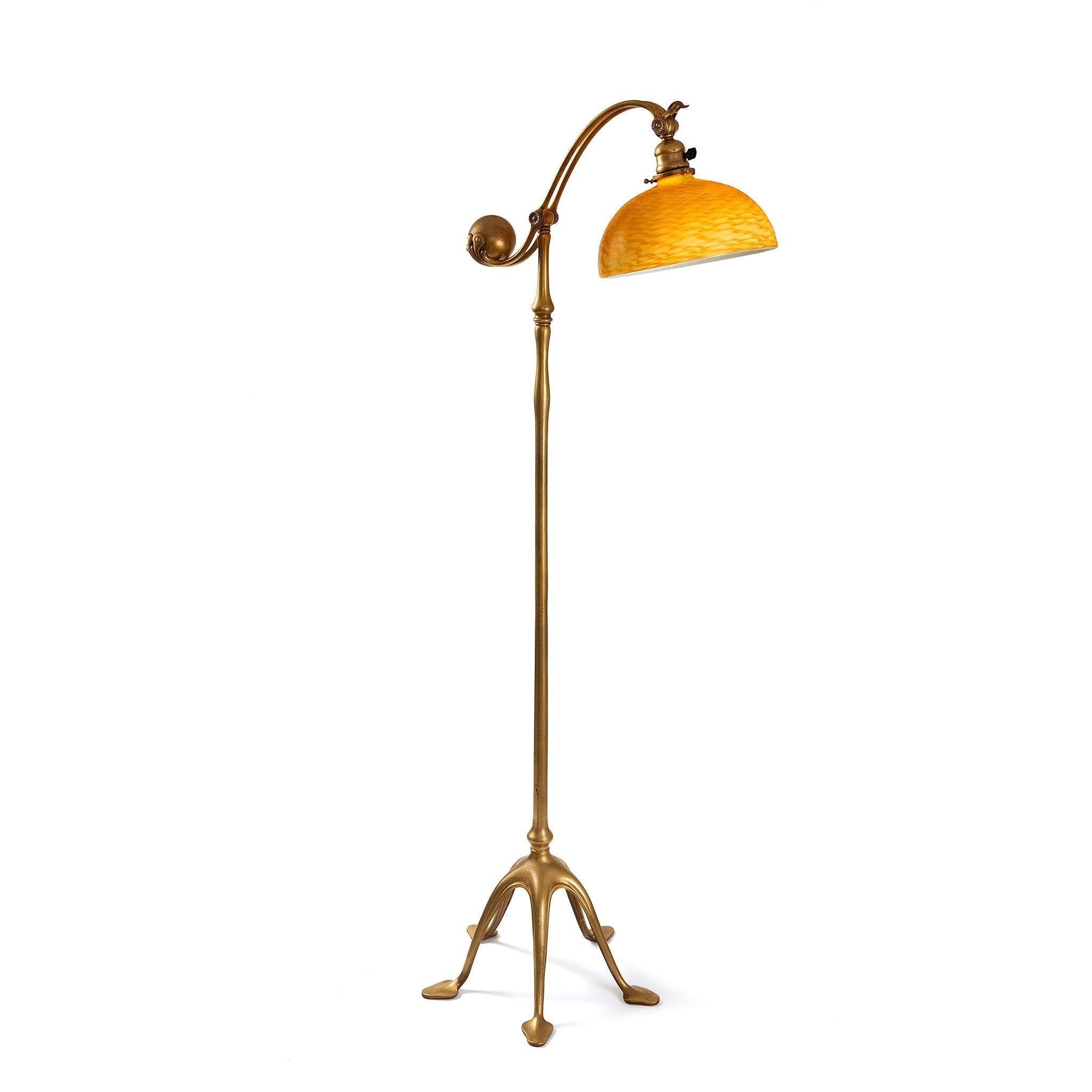 This Tiffany Studios New York glass and gilt bronze floor lamp, features a shimmering twisted gold and amber 