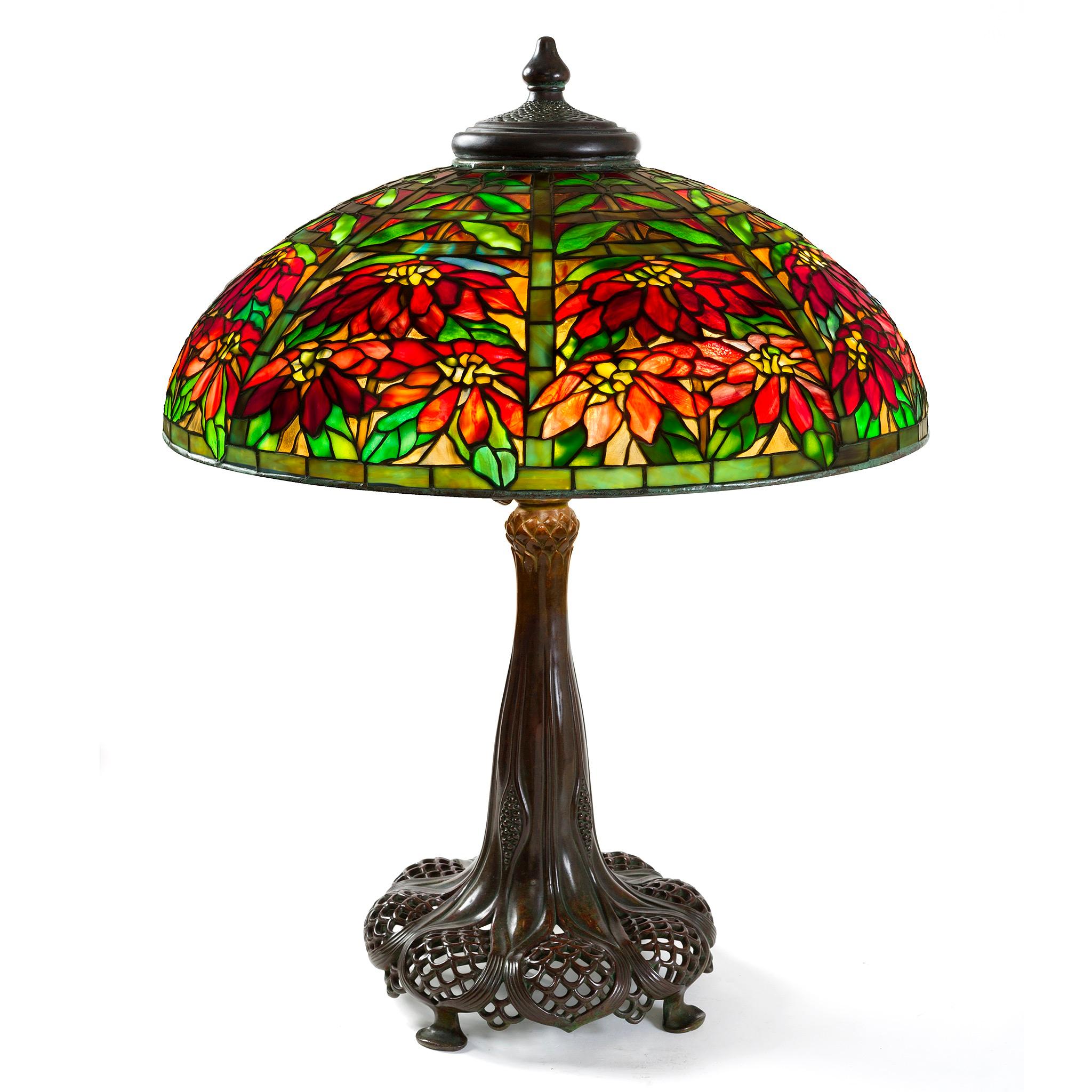 A stunning study in perspective and a charming example of the multifaceted capabilities of Louis Comfort Tiffany's team of designers, the leaded glass shade and bronze base of this 
