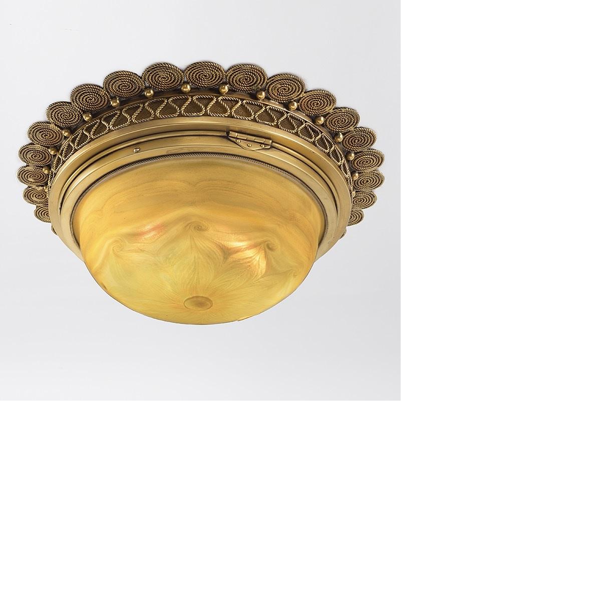A Tiffany Studios New York favrile glass and gilt bronze ceiling fixture. Featuring a decorated favrile glass shade with iridescent pulled feather decoration, circa 1900. 

A similar shade is pictured in: Tiffany Lamps and Metalware: An