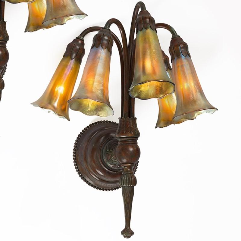 A pair of twin of Tiffany Studios New York patinated bronze and Favrile glass 