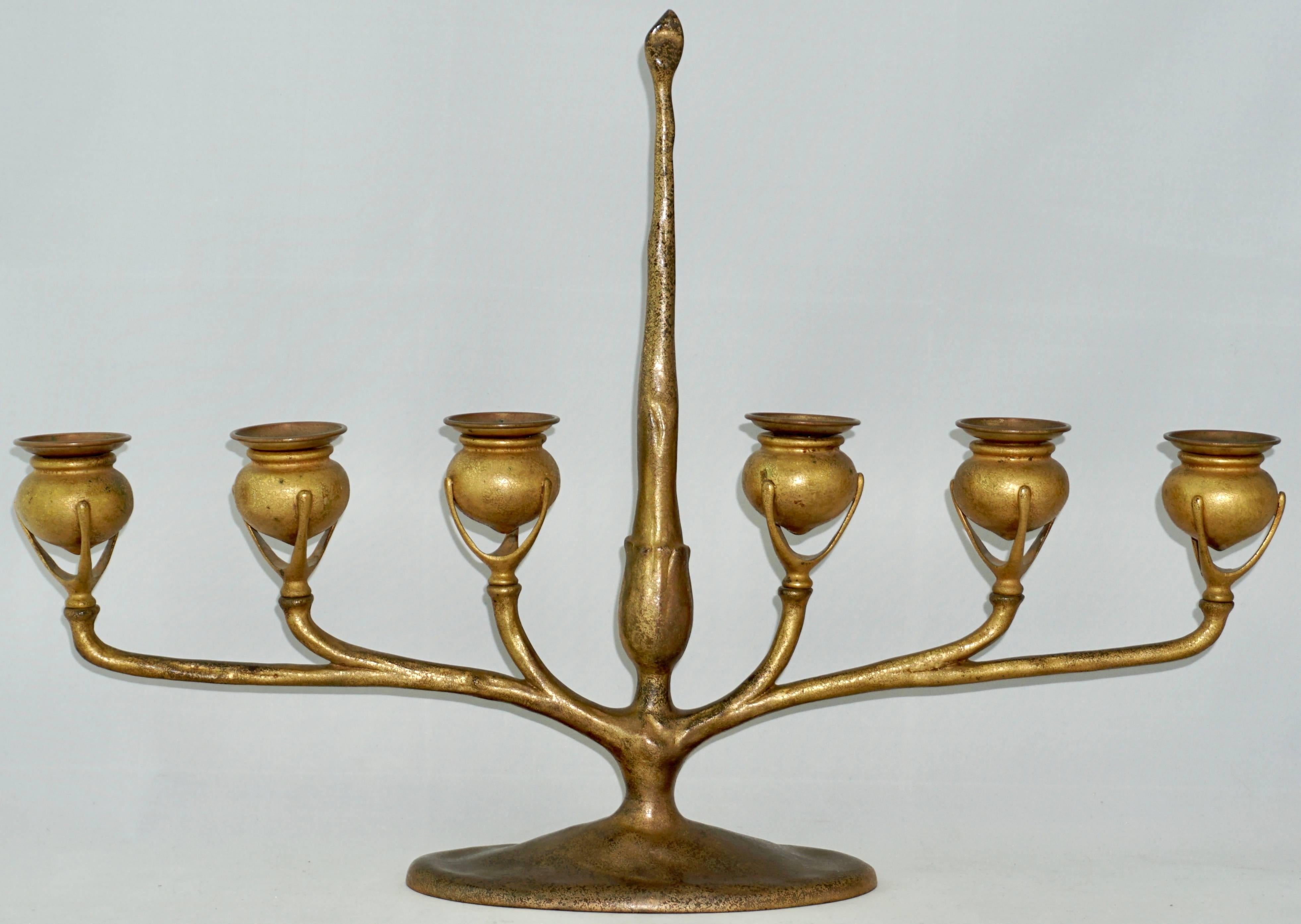 Beautiful Tiffany Studios candelabra, six light form in bronze with center post bearing a fitted candle snuff and extending arms supporting six pod form candle holders with removable bobeches. Original gold doré patina textured. Art Nouveau perfect