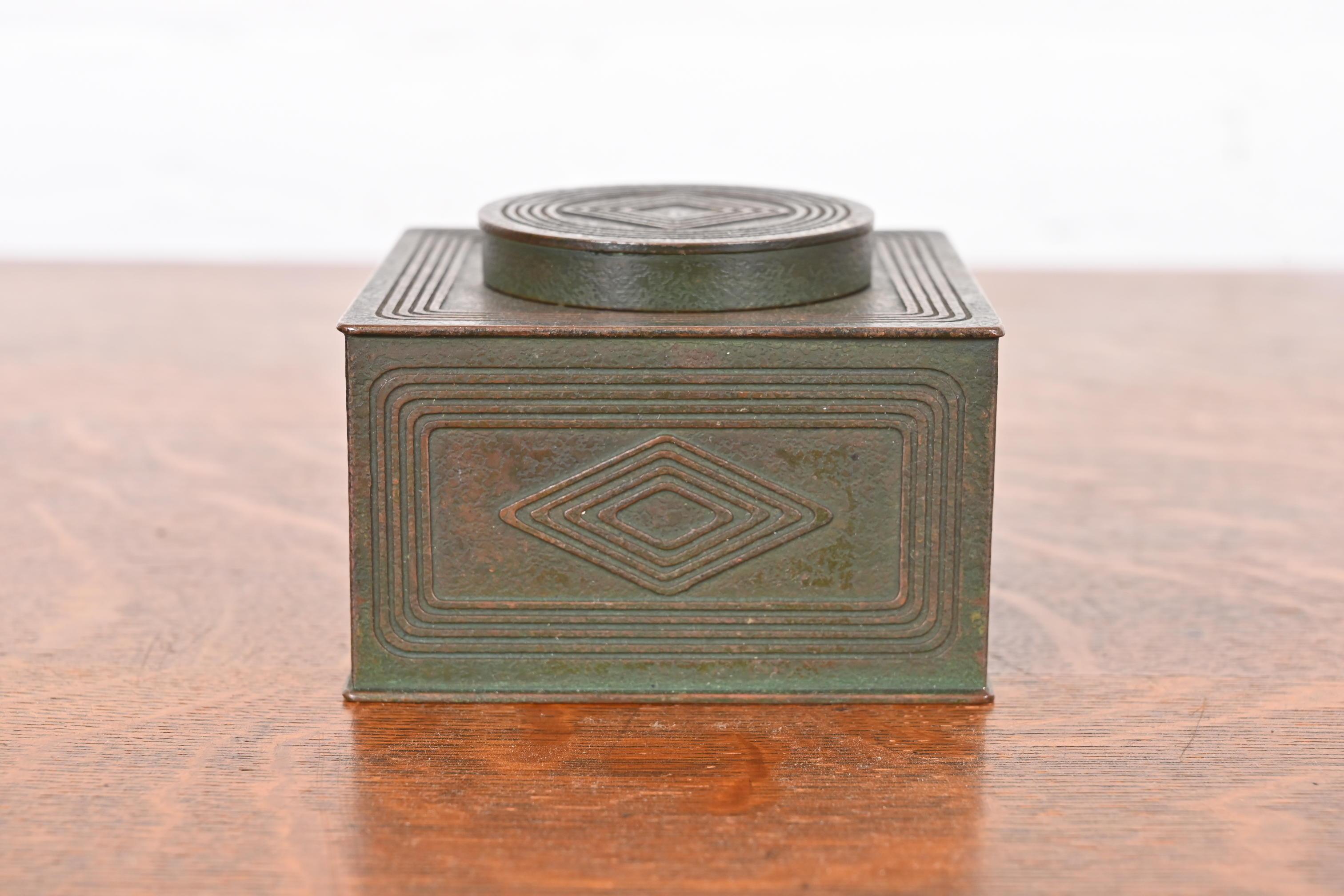A gorgeous antique bronze inkwell featuring the iconic Graduate pattern in verdigris green patina

By Tiffany Studios (signed to the underside)

New York, USA, Early 20th Century

Measures: 3.75