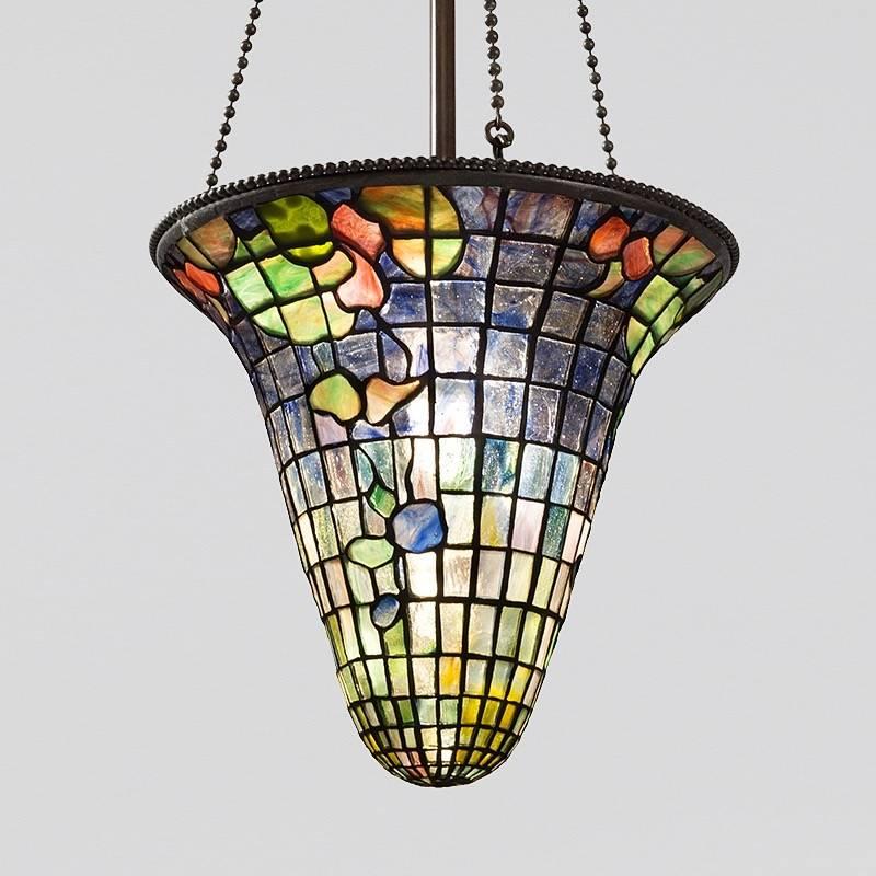 A Tiffany Studios New York leaded glass chandelier. This hanging shade has leaves and petals in green, orange, red and blue against a background that changes gradually from translucent to blue. It is suspended by three bronze chains, circa 1900.

A