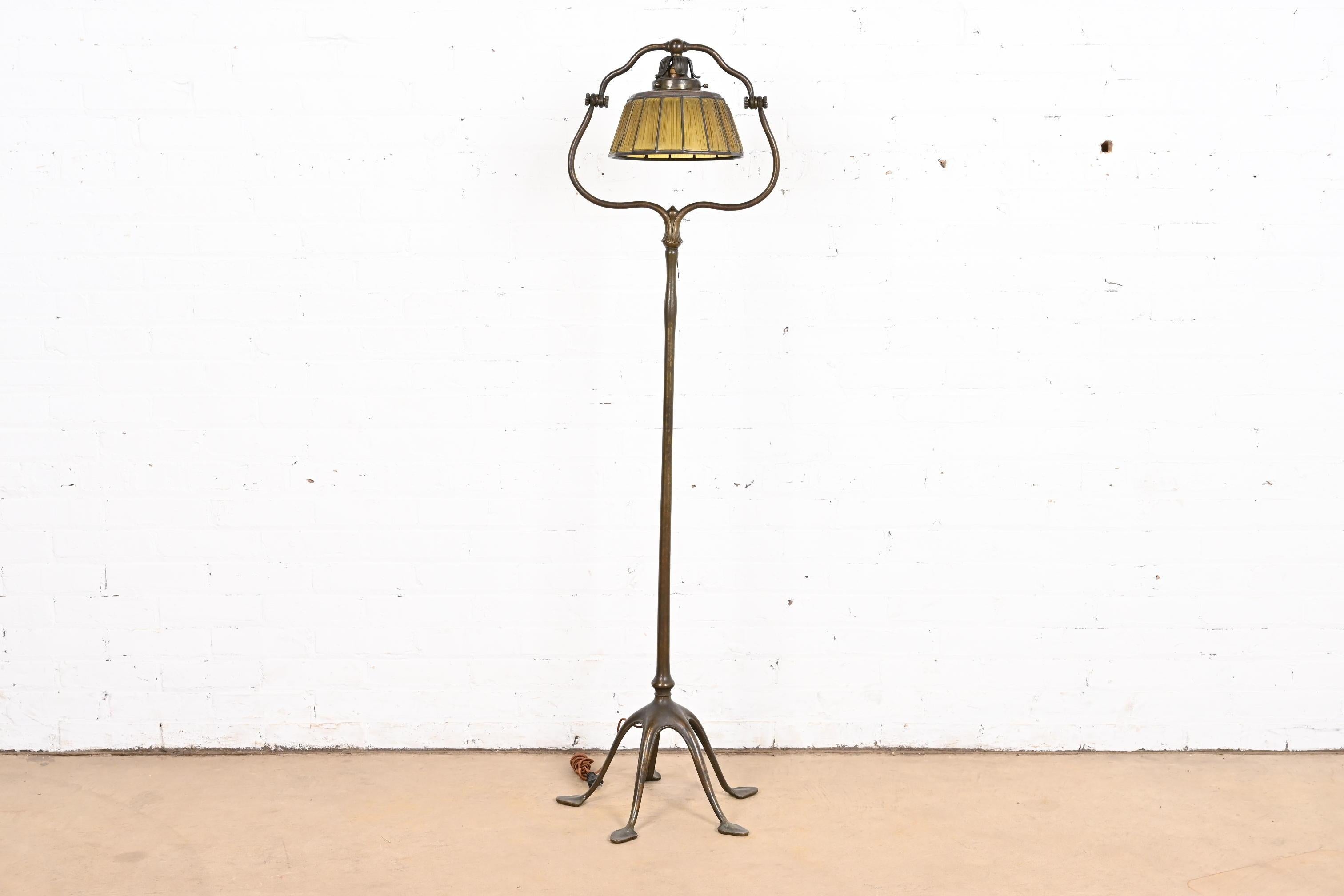 A rare and exceptional Arts & Crafts or Art Deco period bronze harp floor lamp

By Tiffany Studios (shade and base both signed 