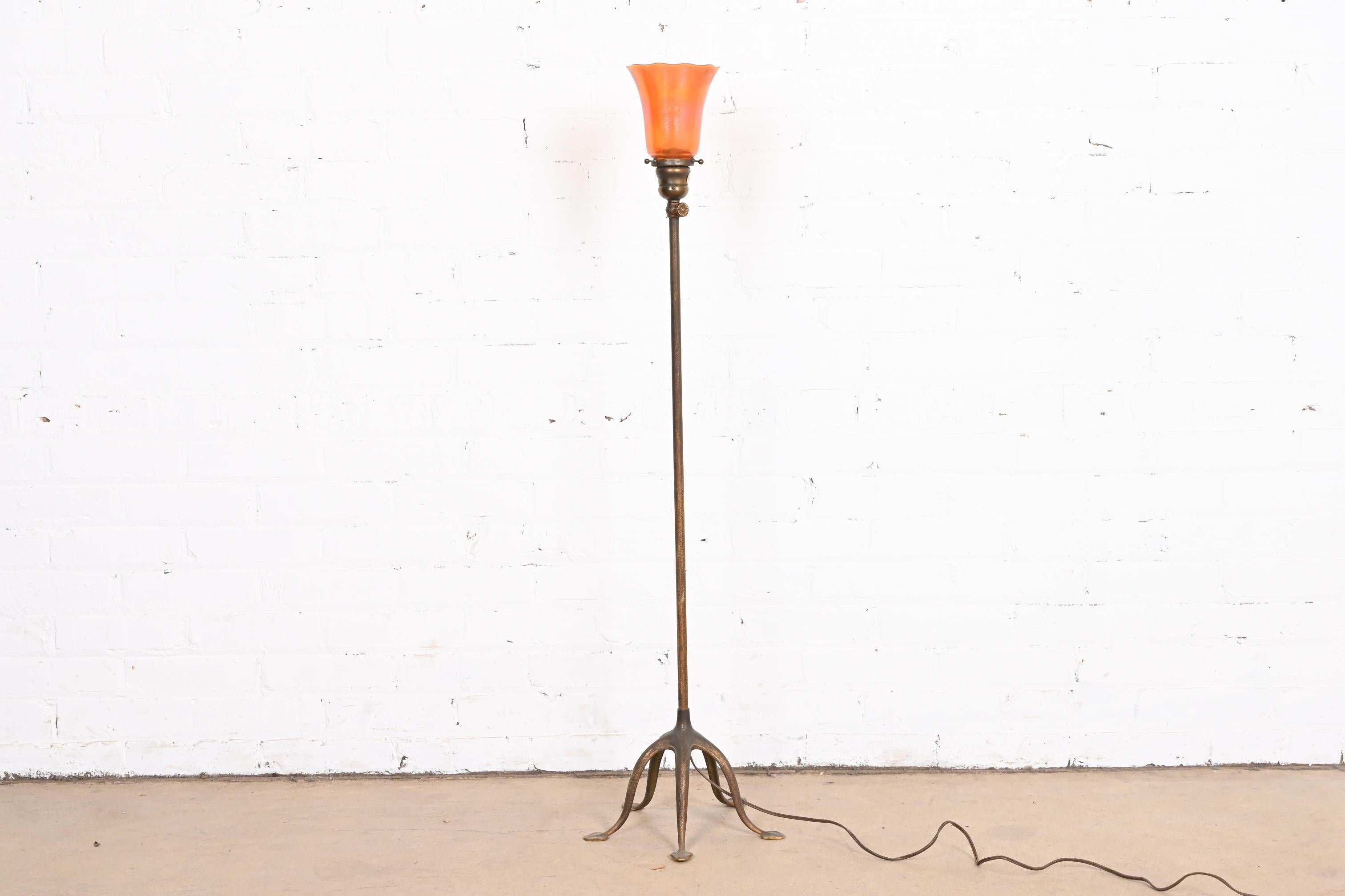 An outstanding Arts & Crafts or Art Deco period adjustable floor lamp

By Tiffany Studios

New York, USA, Early 20th Century

Patinated gilt bronze stand, with gorgeous Nuart favrile style blown glass shade.

Measures: 11