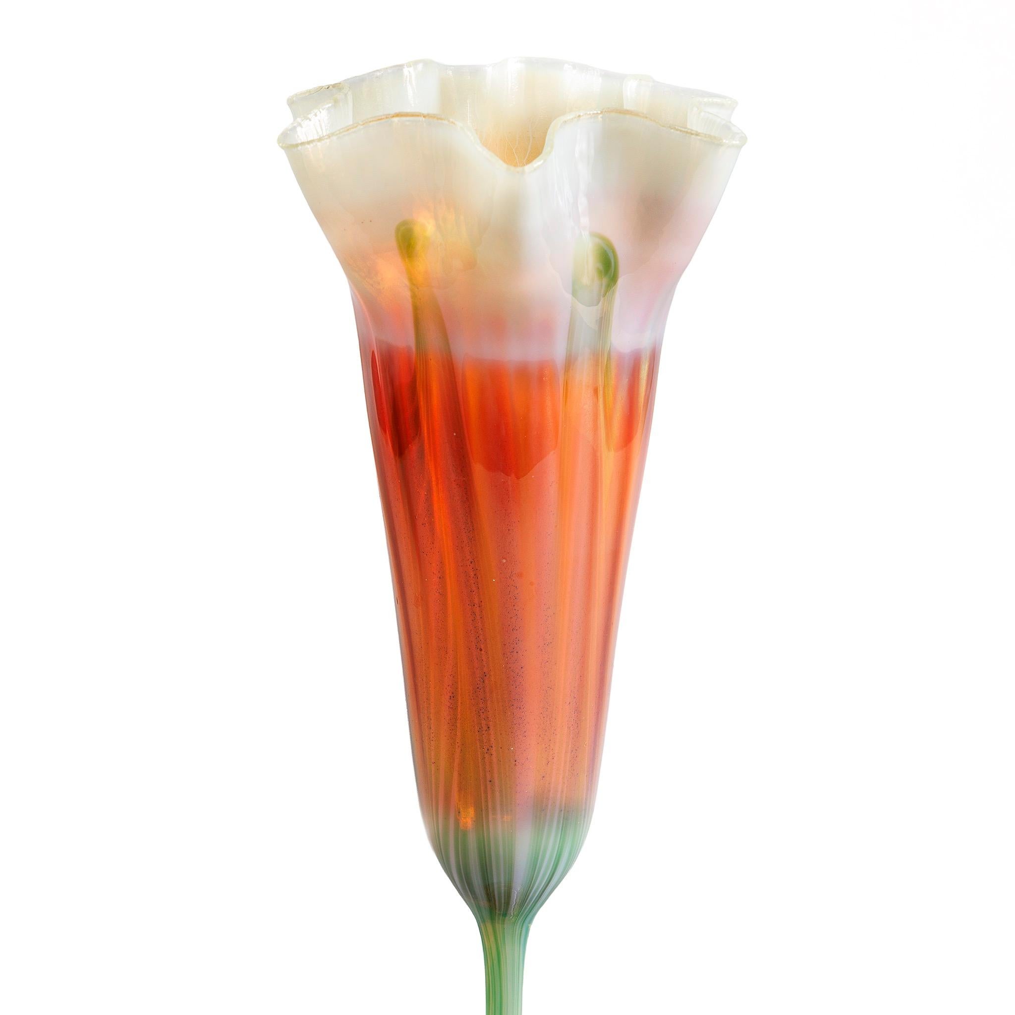 Ce vase floriforme magnifiquement coloré des studios Tiffany est une pièce délicate dont les couleurs brillantes et les formes dynamiques confèrent une force au design qui est en contradiction flagrante avec la modestie de la composition de l'œuvre.