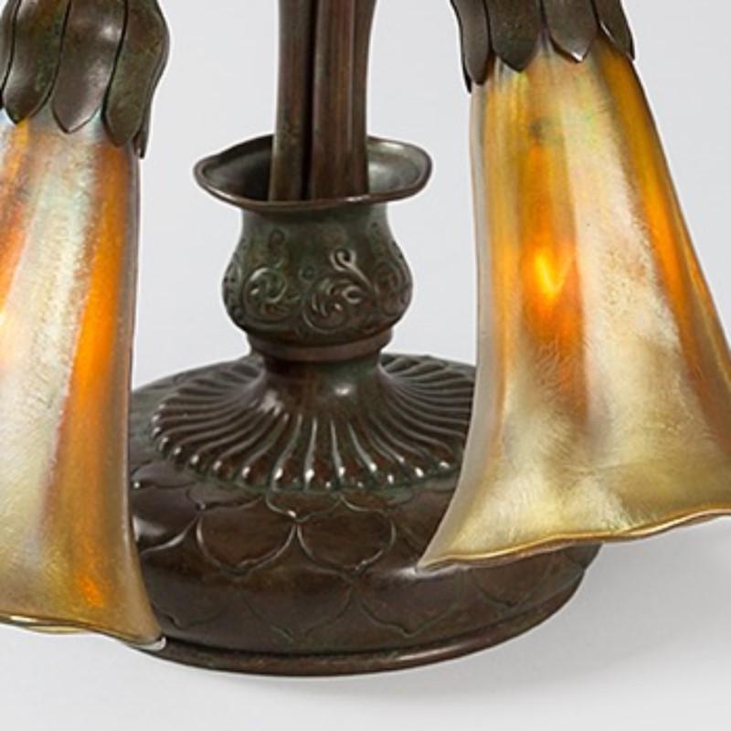 This Tiffany Studios New York glass and bronze piano table lamp features the firm's beloved shape, 